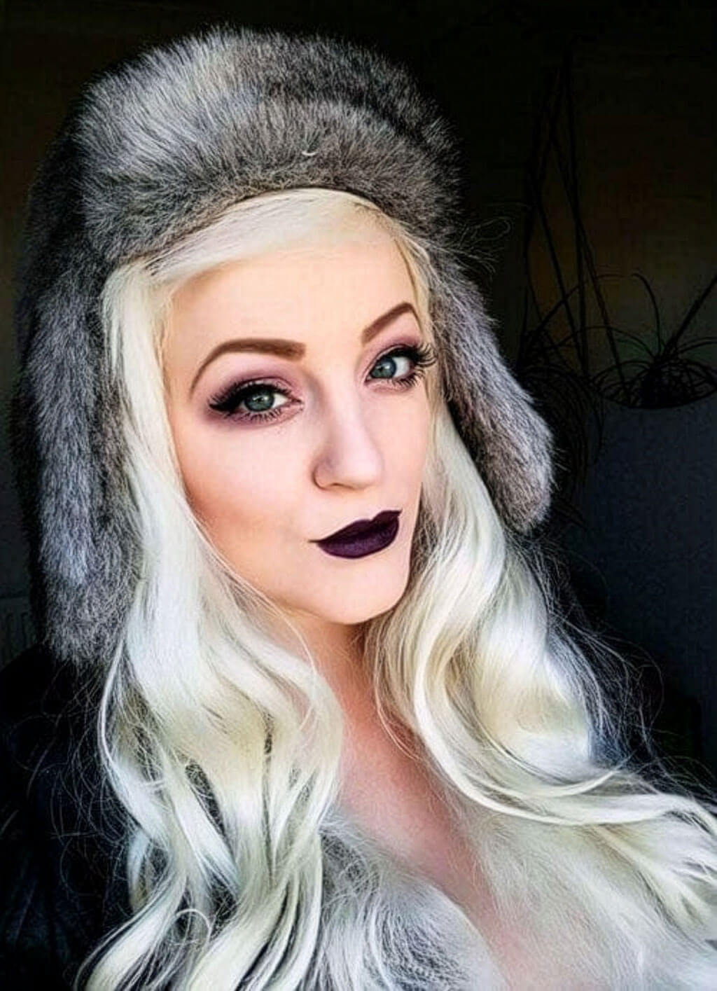 Person with long blonde hair and dark lipstick wearing a gray furry hat. Annabelle's Wigs synthetic wig Platinum blonde half wig hairpiece (3/4 wig), wavy: Barbie