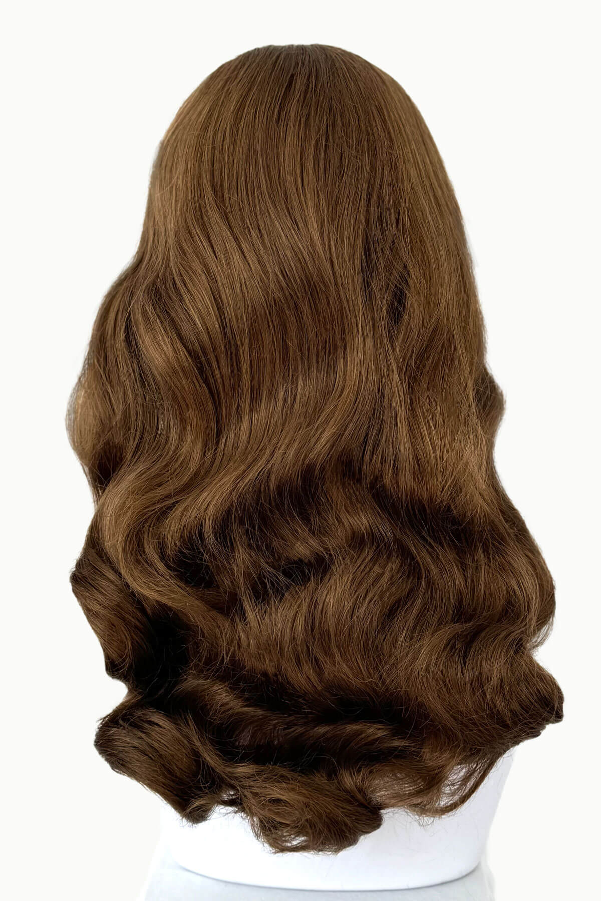 Brown wig on a white mannequin head with a plain background. Brown 1950s pinup style wig, with long waves and a short fringe: Rosie golden brown 12-27