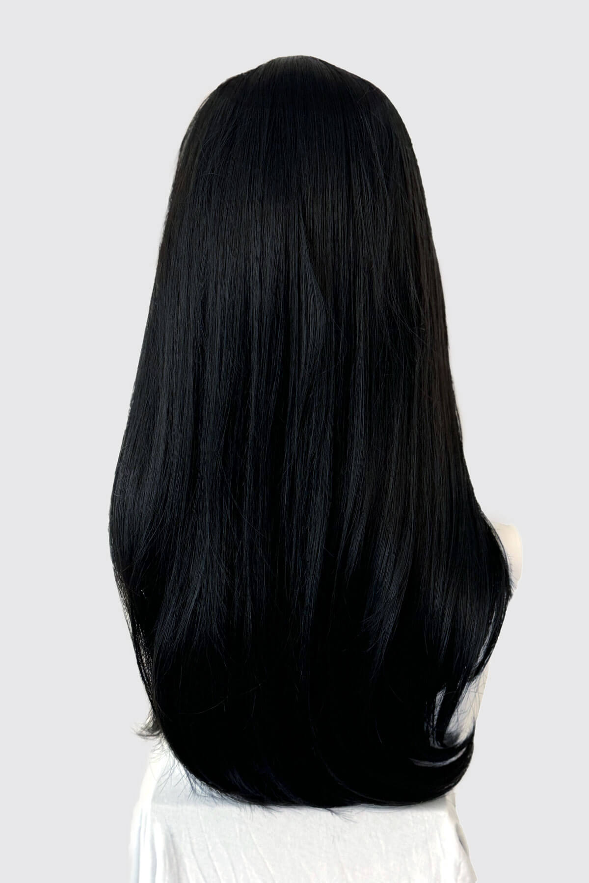 Straight black wig on a mannequin. Long black wig, face frame style with full, sweeping fringe: Corina