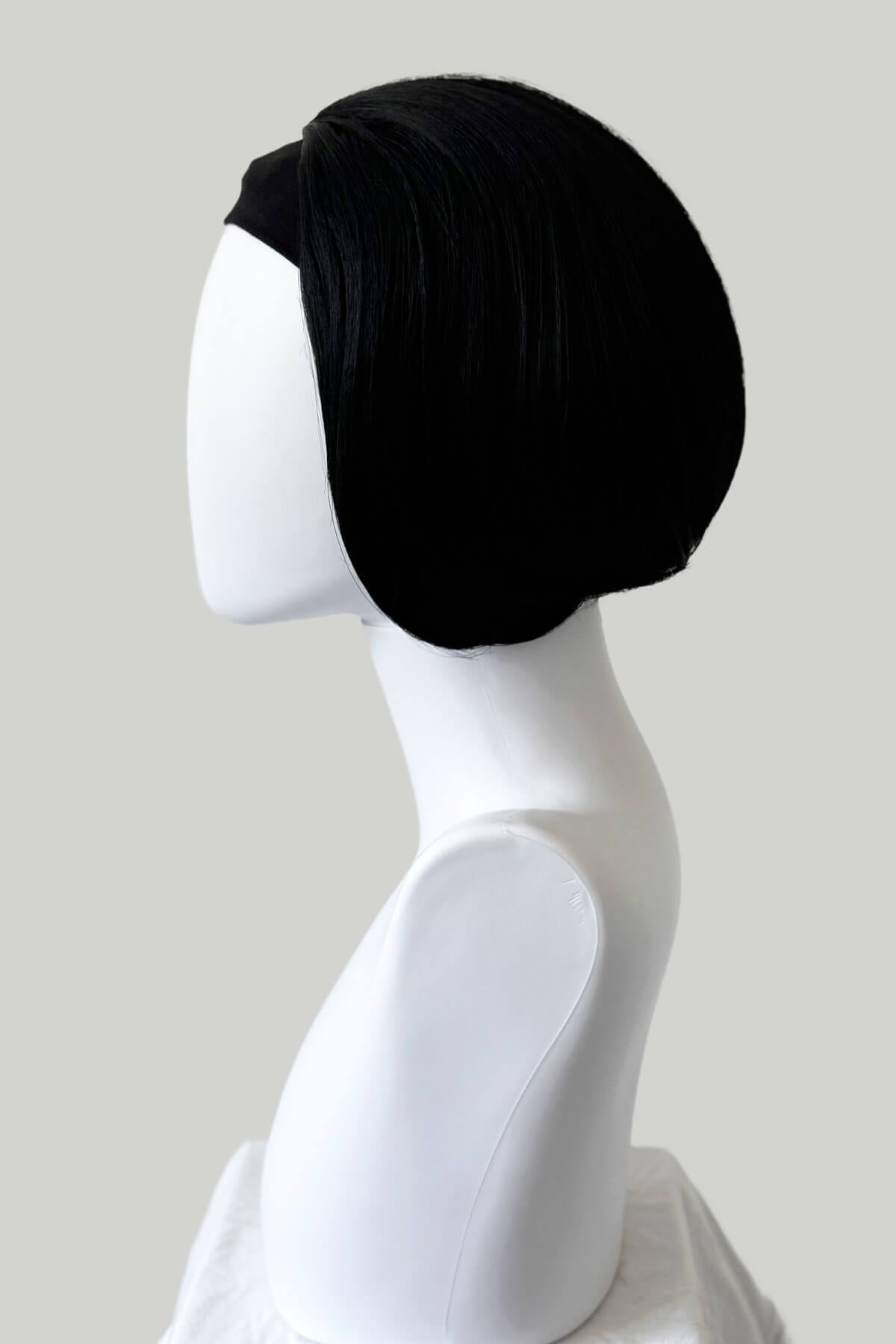 Black headscarf on a white mannequin head against a plain background. Bob half wig hairpiece, Flexihair: Amelie black 1b