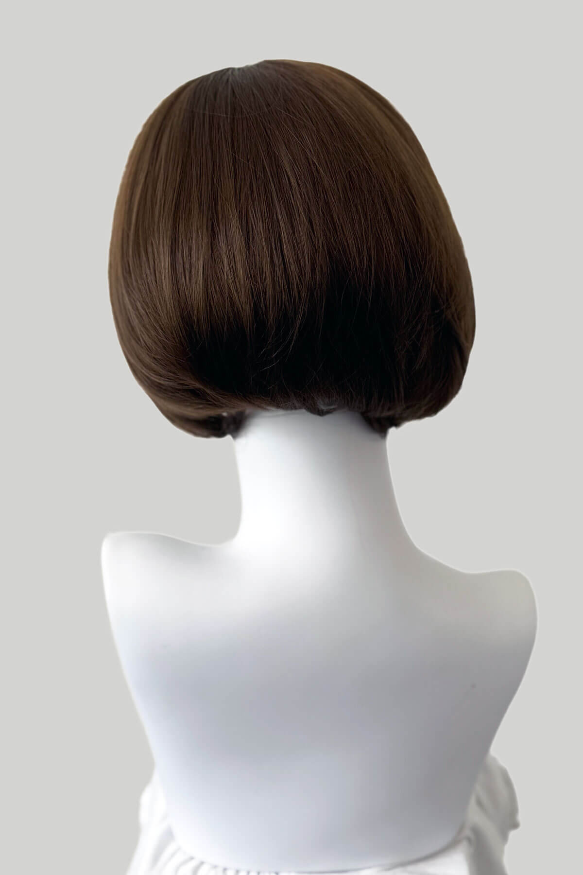Brown wig on a mannequin head against a white background. Bob half wig hairpiece, Flexihair: Amelie chestnut brown 8