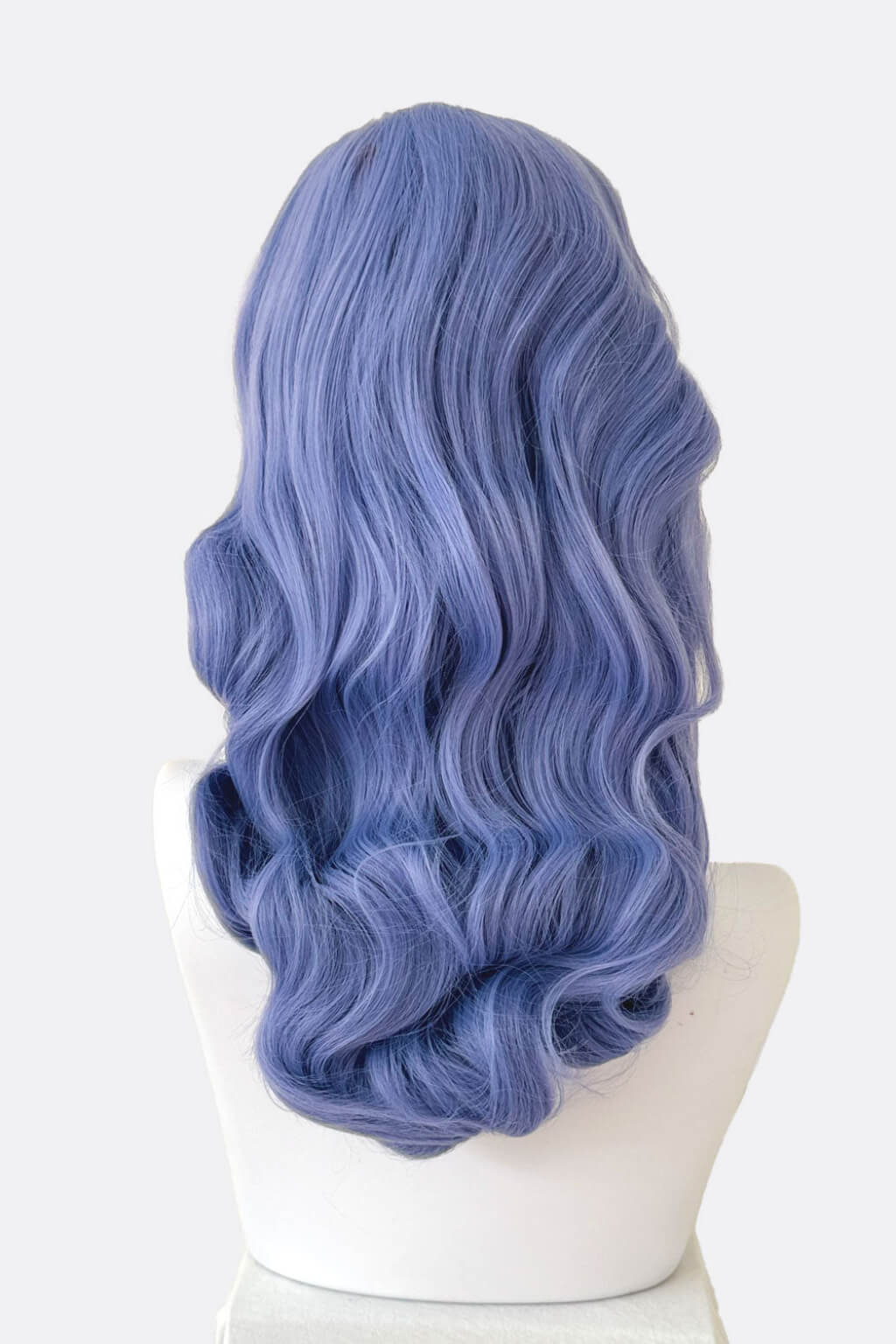 Blue wig on a mannequin head against a white background. Long blue-purple wig with short fringe and old Hollywood waves: Ophelia