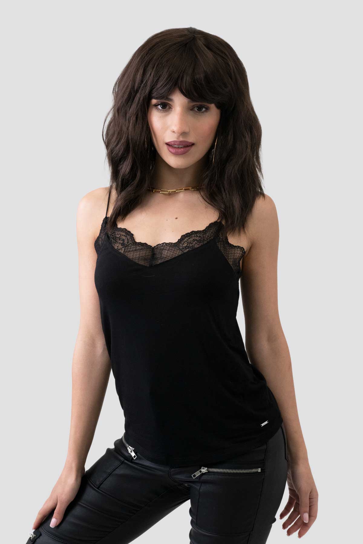 Woman wearing a black lace-trimmed top against a plain background. Dark chocolate brown long wavy bob wig: Roxy