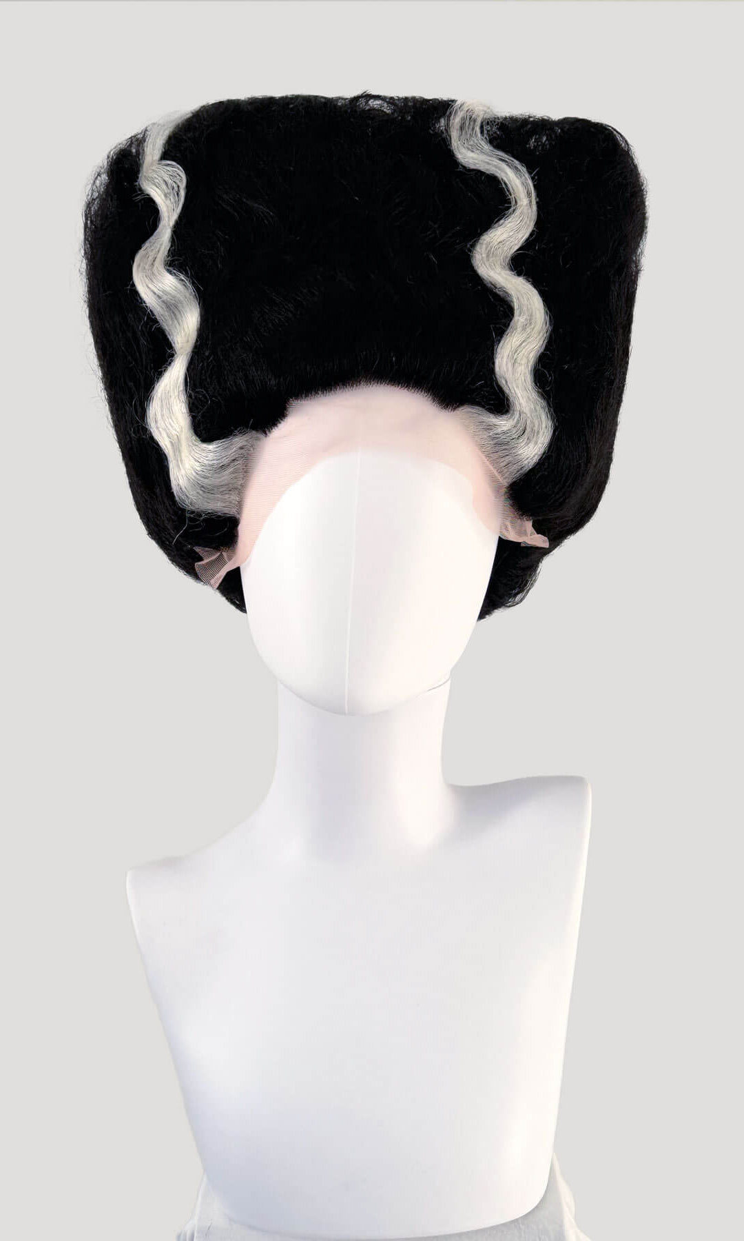 Black wig with white fringe on a mannequin head against a white background. Bride of Frankenstein lacefront wig, black with platinum streaks: Eva