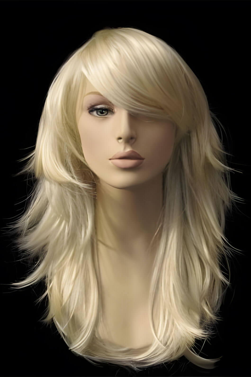 Blonde wig on a mannequin head against a black background. Light blonde wig, long, layered, tip flip: Gabriella