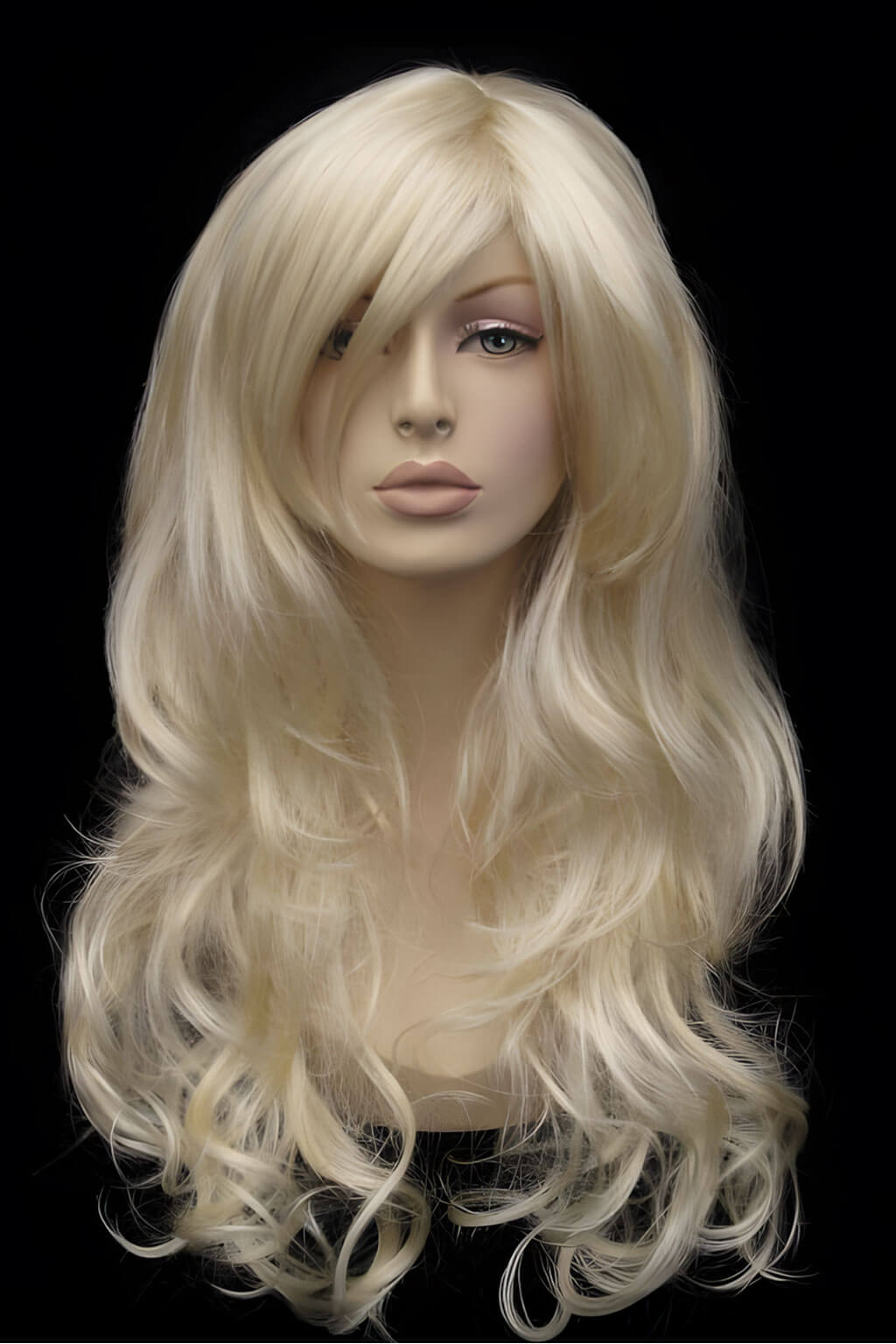 Blonde wig on a mannequin head against a black background. Blonde wig with big loose curls and sweeping fringe, extra long: Carly champagne blonde 613