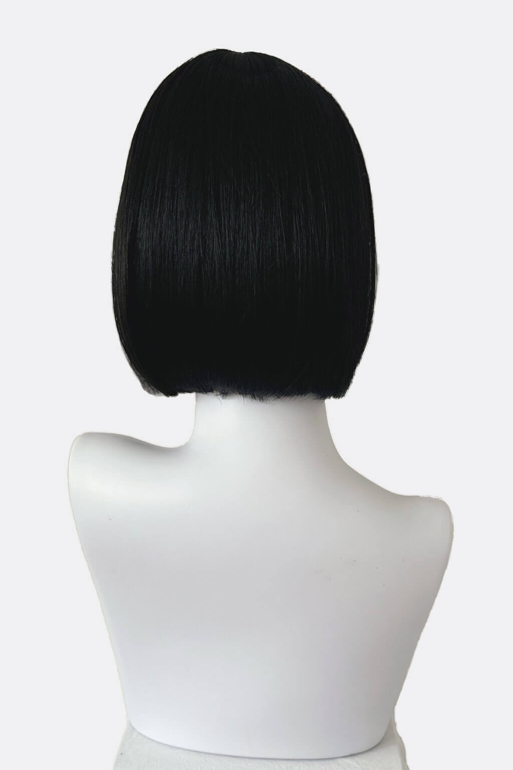 Black bob wig on a mannequin head against a white background. Short black bob wig: Josie