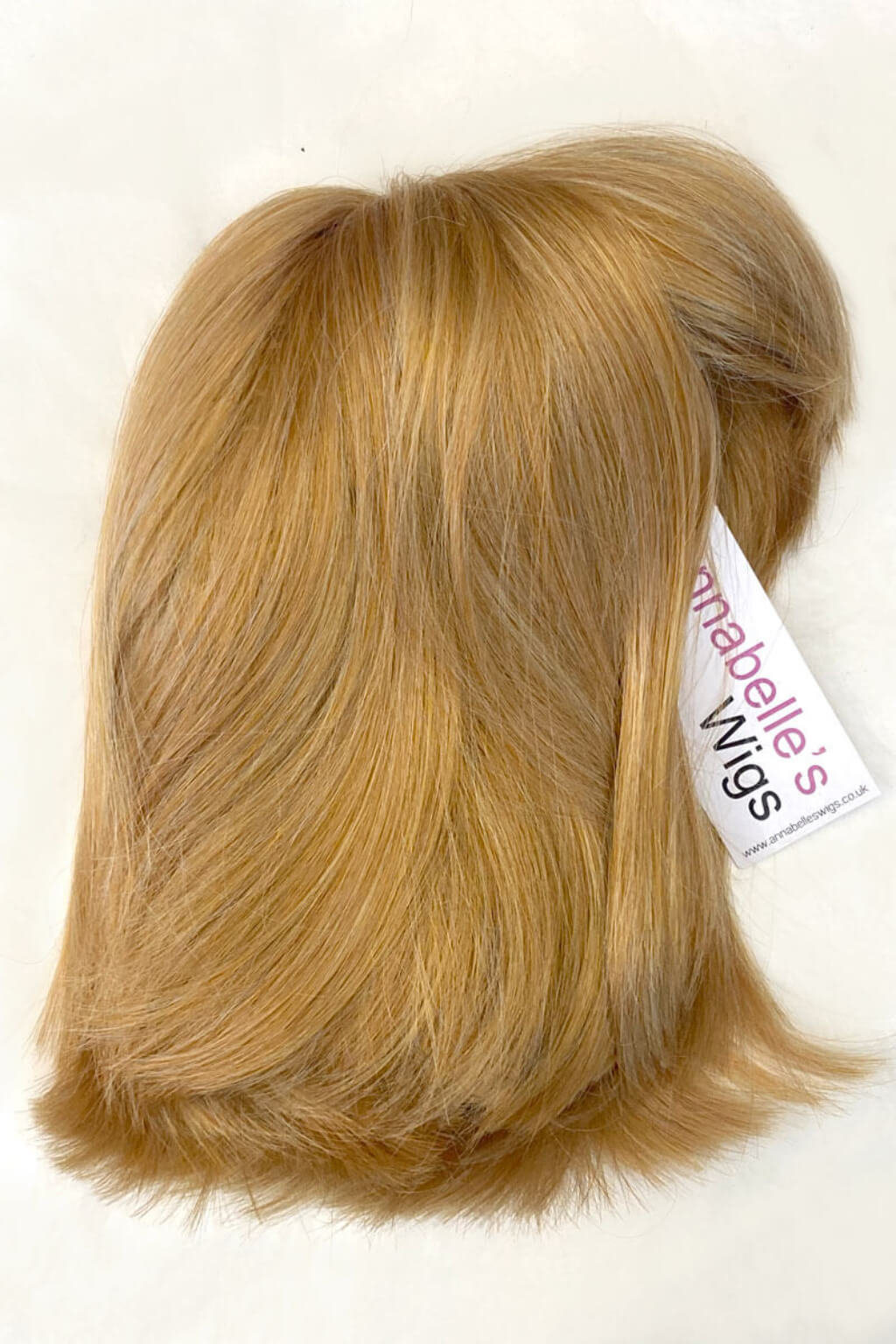Blonde wig on a white background. Blonde bob wig with fringe: Gracie 24C