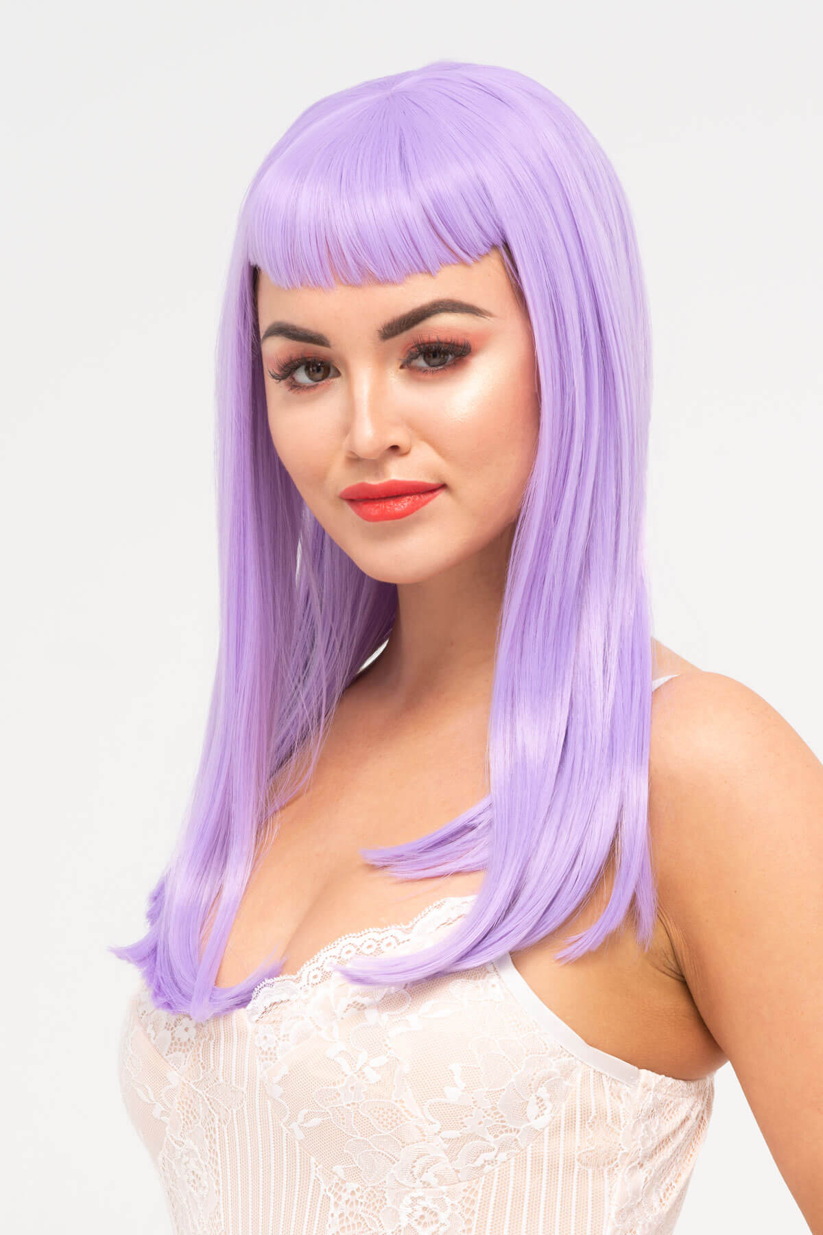 Woman wearing a purple wig on a white background. Long, Pink-Purple Wig With Short, Straight Fringe: Seraphina