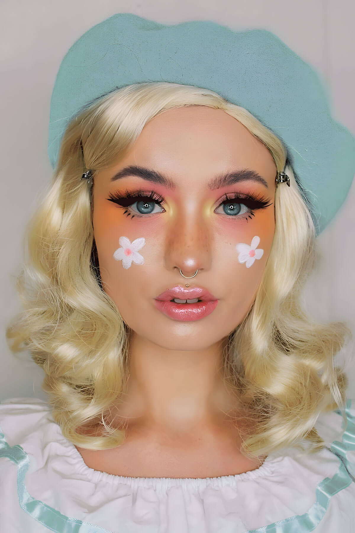 Person with blonde wig, blue beret, and floral face paint against a plain background. 40s blonde pinup style wig with marcel waves: Lauren