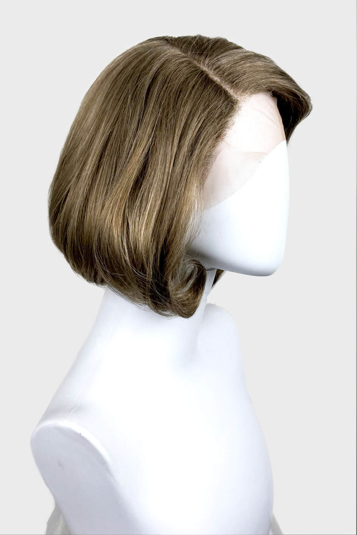 Mannequin head with a brown wig on a white background. Dark golden wig, lace front, rockabilly style with victory rolls: Bobbie