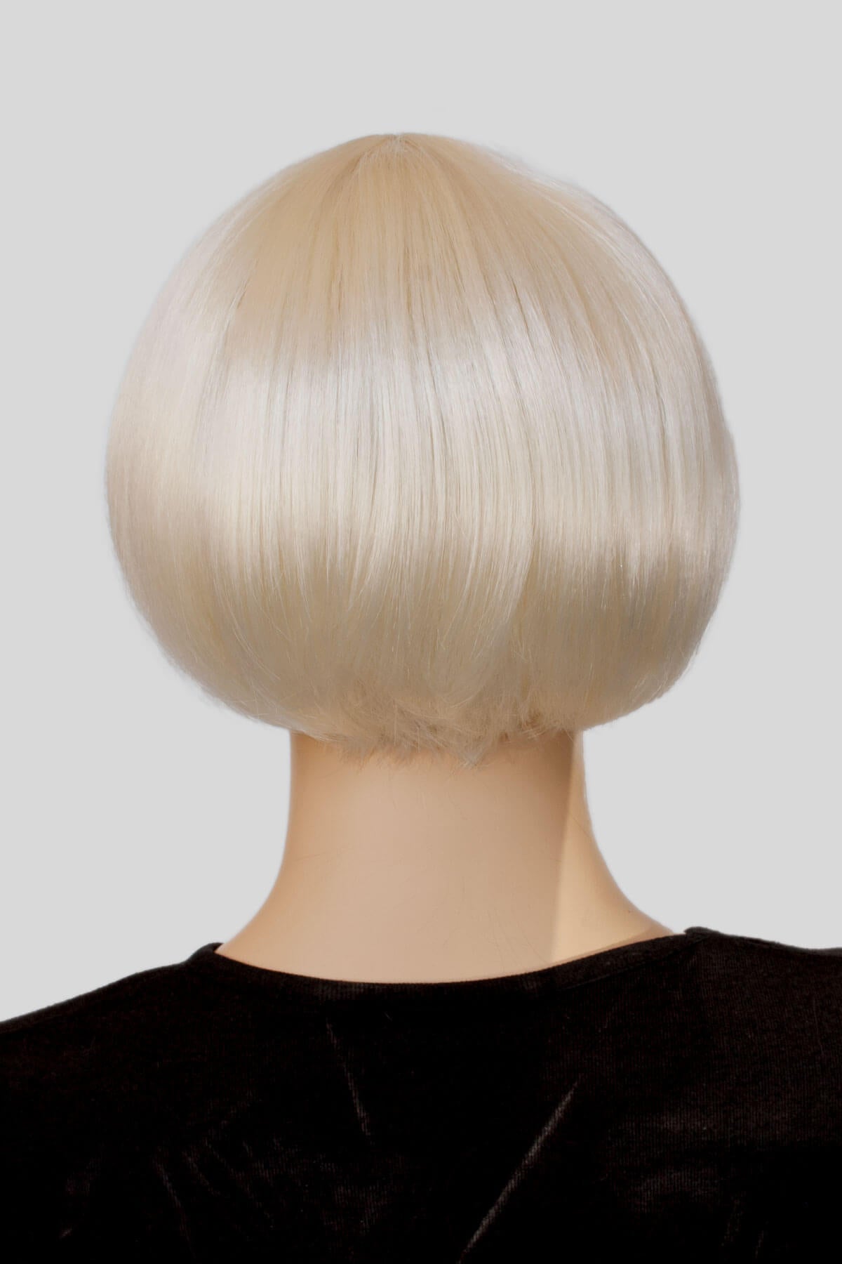 Blonde bob wig on a mannequin head against a plain background. Blonde 1920s bob wig, short, Louise Brooks style: Agyness