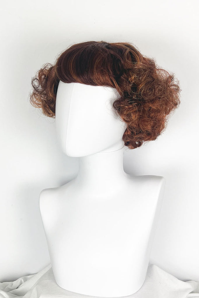 A short red, auburn and blonde mix vintage style wig with waves: Solana