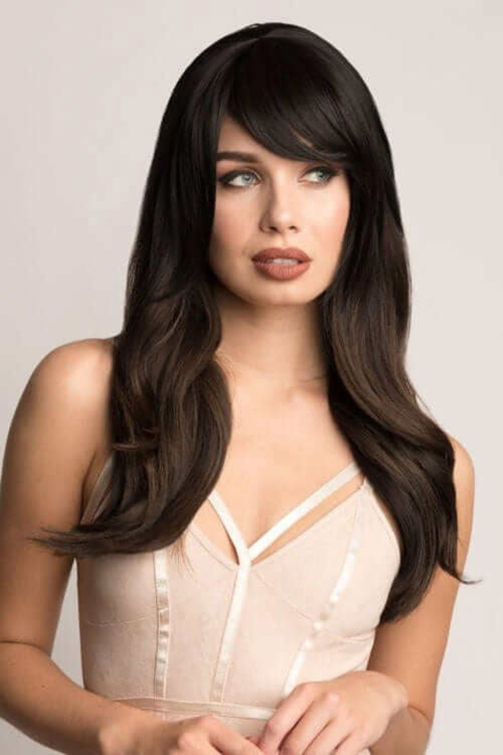 A woman wearing a clip-in fringe hairpiece with straight, long hair extending to her shoulders. Clip in fringe hairpiece, thick, long, sweeping/clip-in bangs: Nova