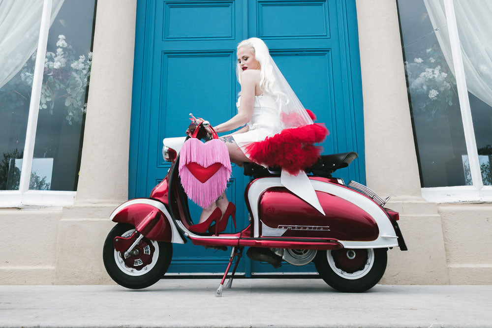 Vintage wedding hair - Bride with long blonde hair on a moped