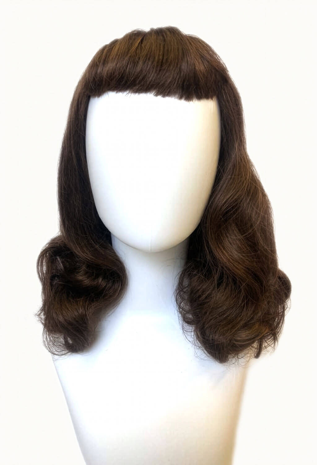 Brown wig on a mannequin head against a white background. Brown pinup style wig, curled with short fringe: Carolina brown and blonde 8H27