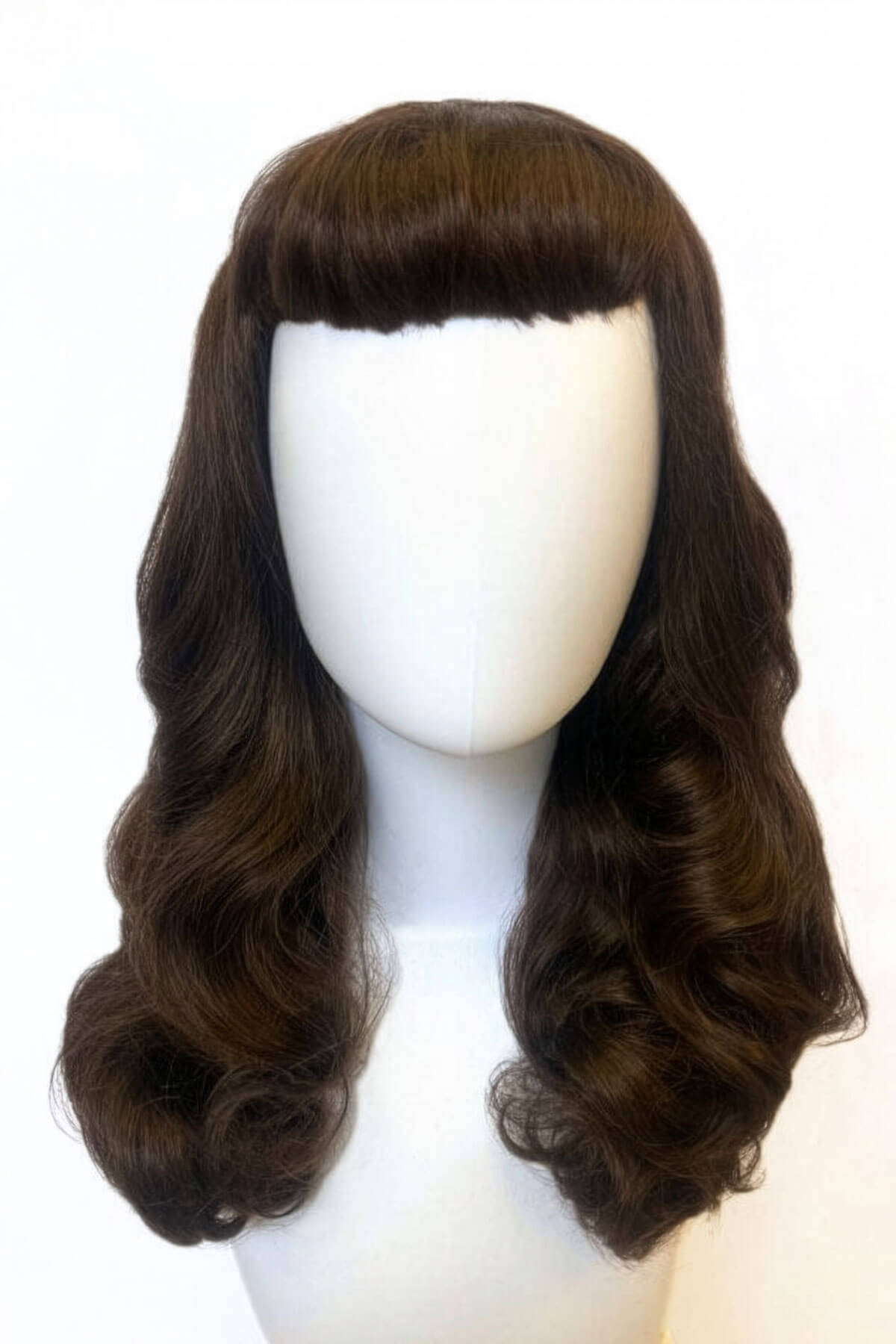 Brown wig with a clip-on fringe on a mannequin head against a white background. Brown 1950s pinup style wig, with long waves and a short fringe: Rosie chestnut brown 8