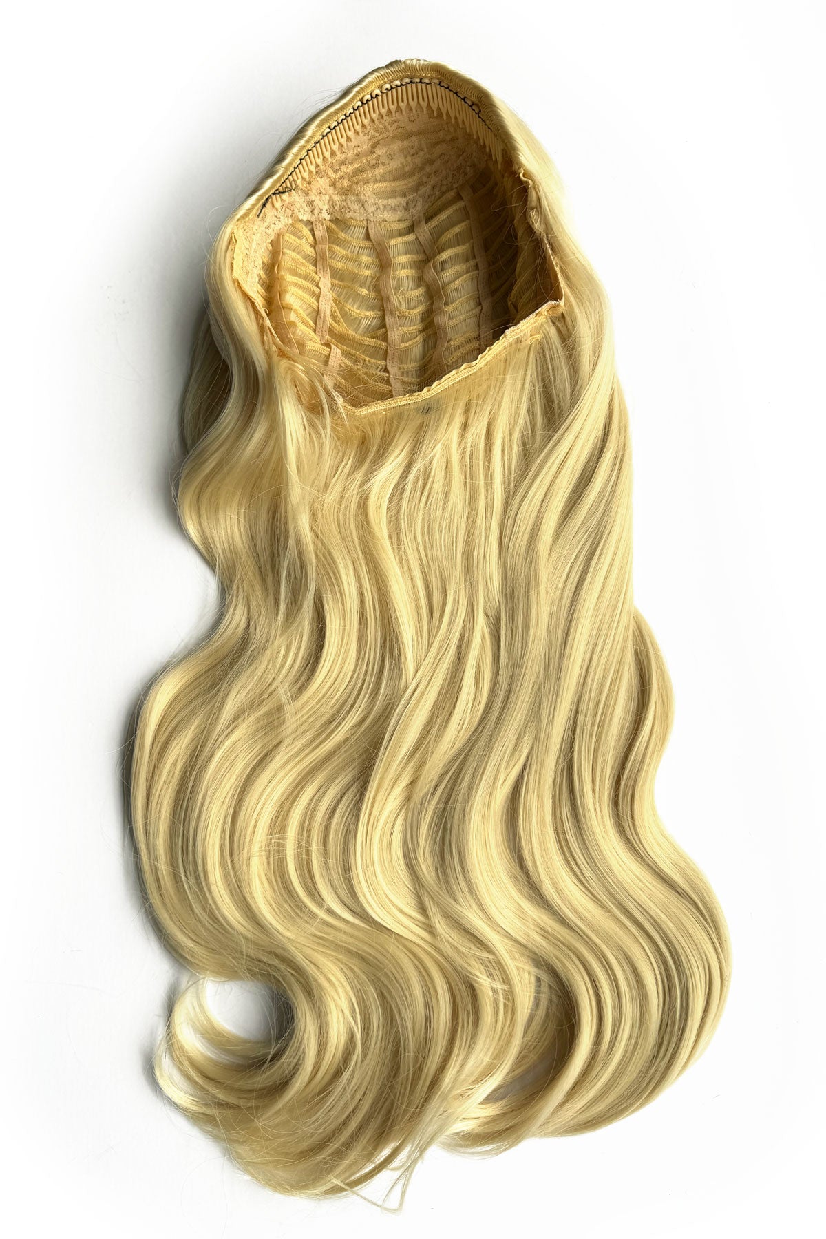 Blonde hair extension on a white background. Heat styleable half wig hairpiece, long wavy, Flexihair: Antoinette creamy blonde 613