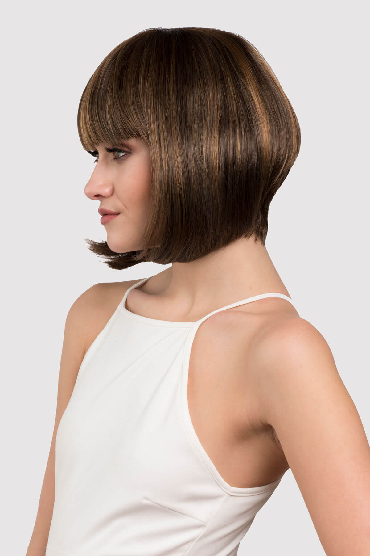 woman wearing a brown wig with blonde highlights. Chocolate brown inverted bob wig with blonde highlights: Keira