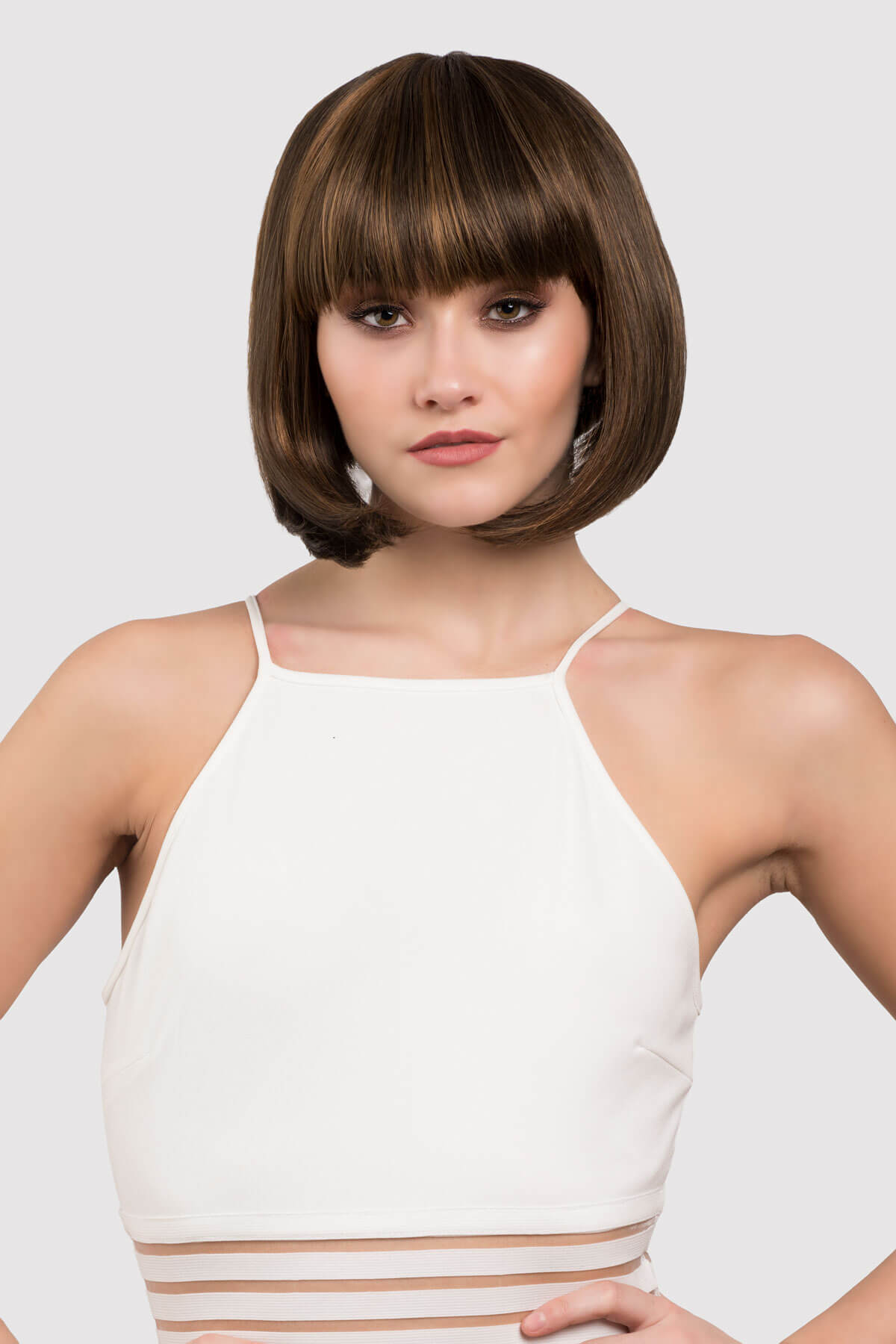 woman wearing a brown wig with blonde highlights. Chocolate brown inverted bob wig with blonde highlights: Keira