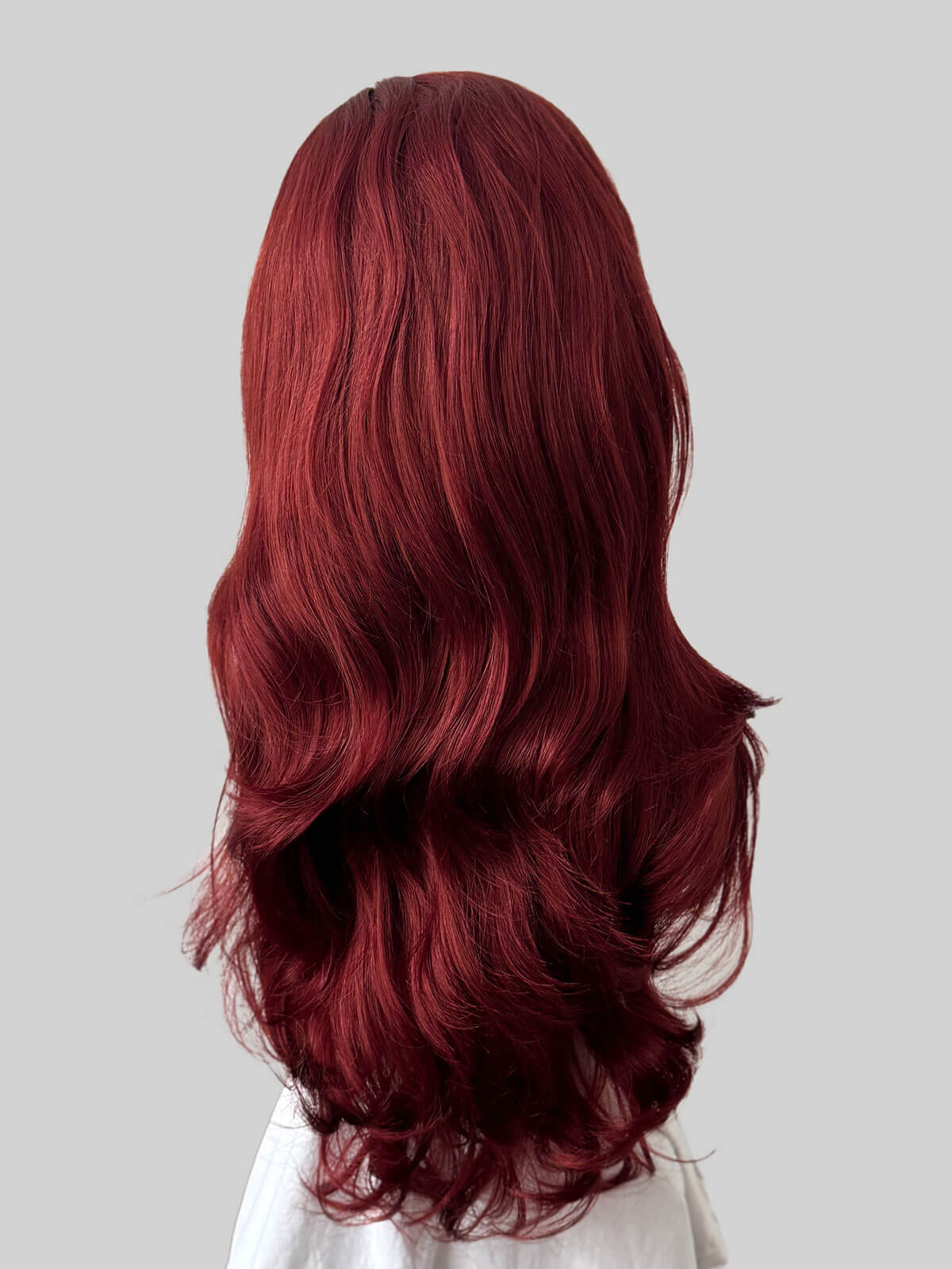 Red wig on a mannequin head against a white background. Red half wig hairpiece (3/4 wig), big loose curls: Verity copper red and wine red 350-39