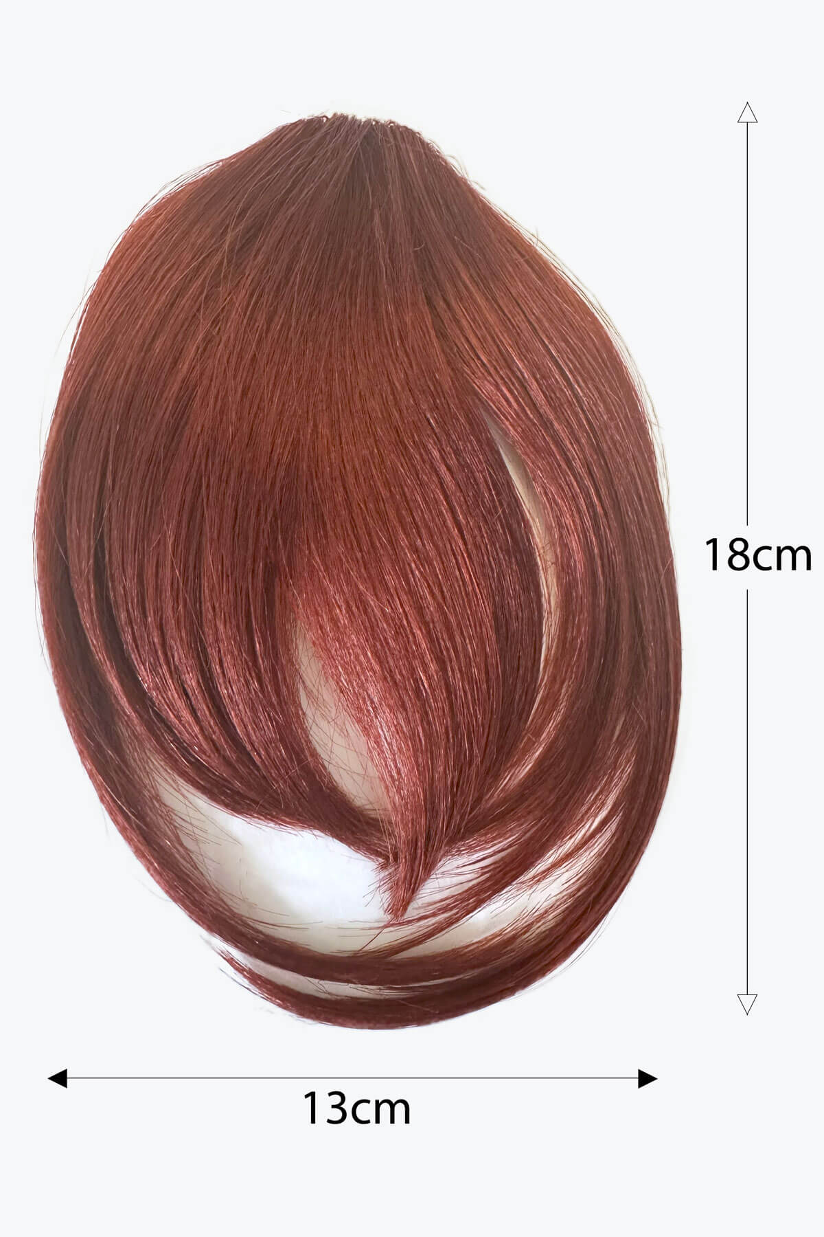 Brown hair extension with measurements on a white background. Clip in fringe hairpiece/clip-in bangs, gently feathered with face framing whisps: Delia copper red 130