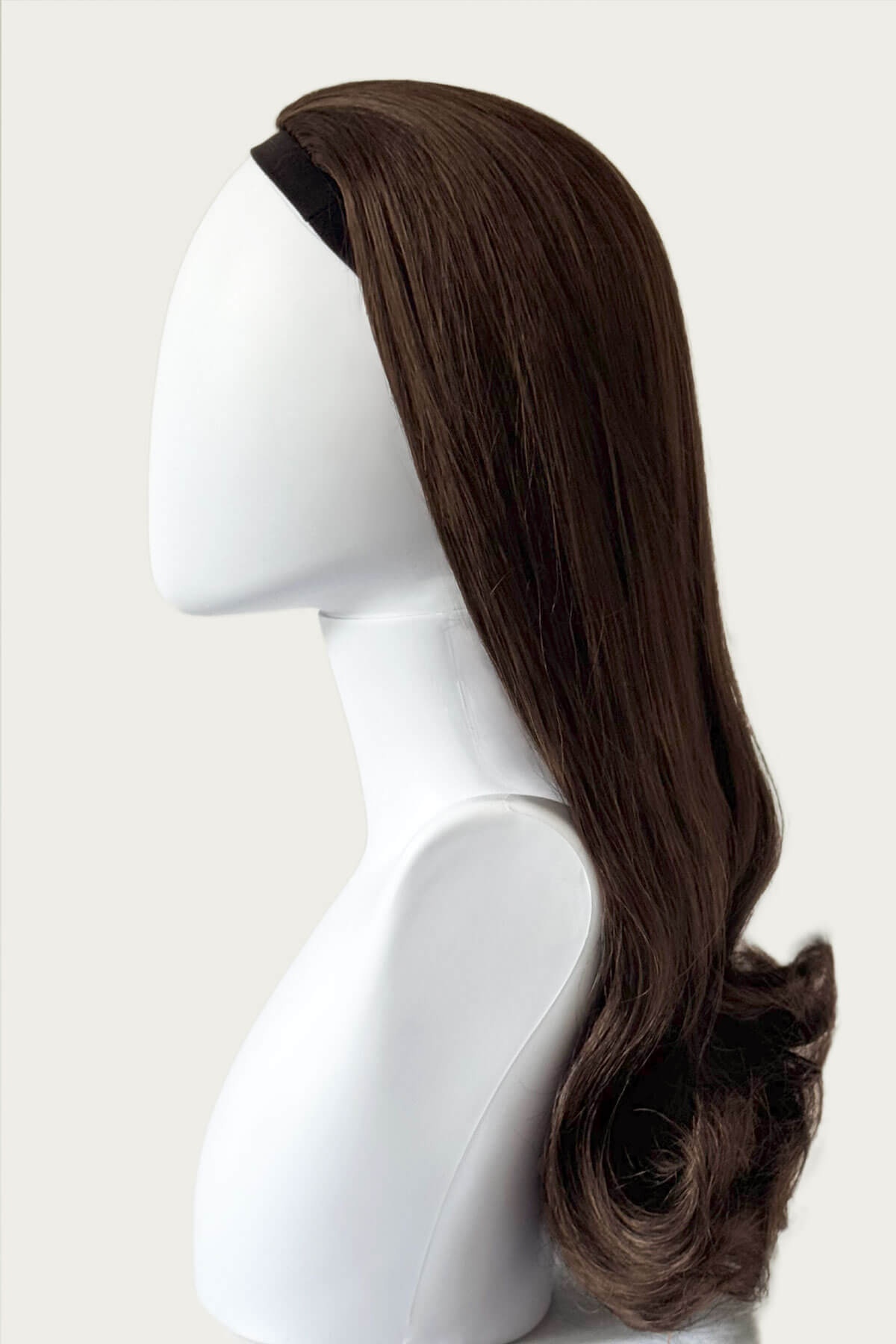 Brown wig on a mannequin head against a white background. 1960s Retro high crown, half wig hairpiece, long with hair flip: Priscilla chestnut brown 8