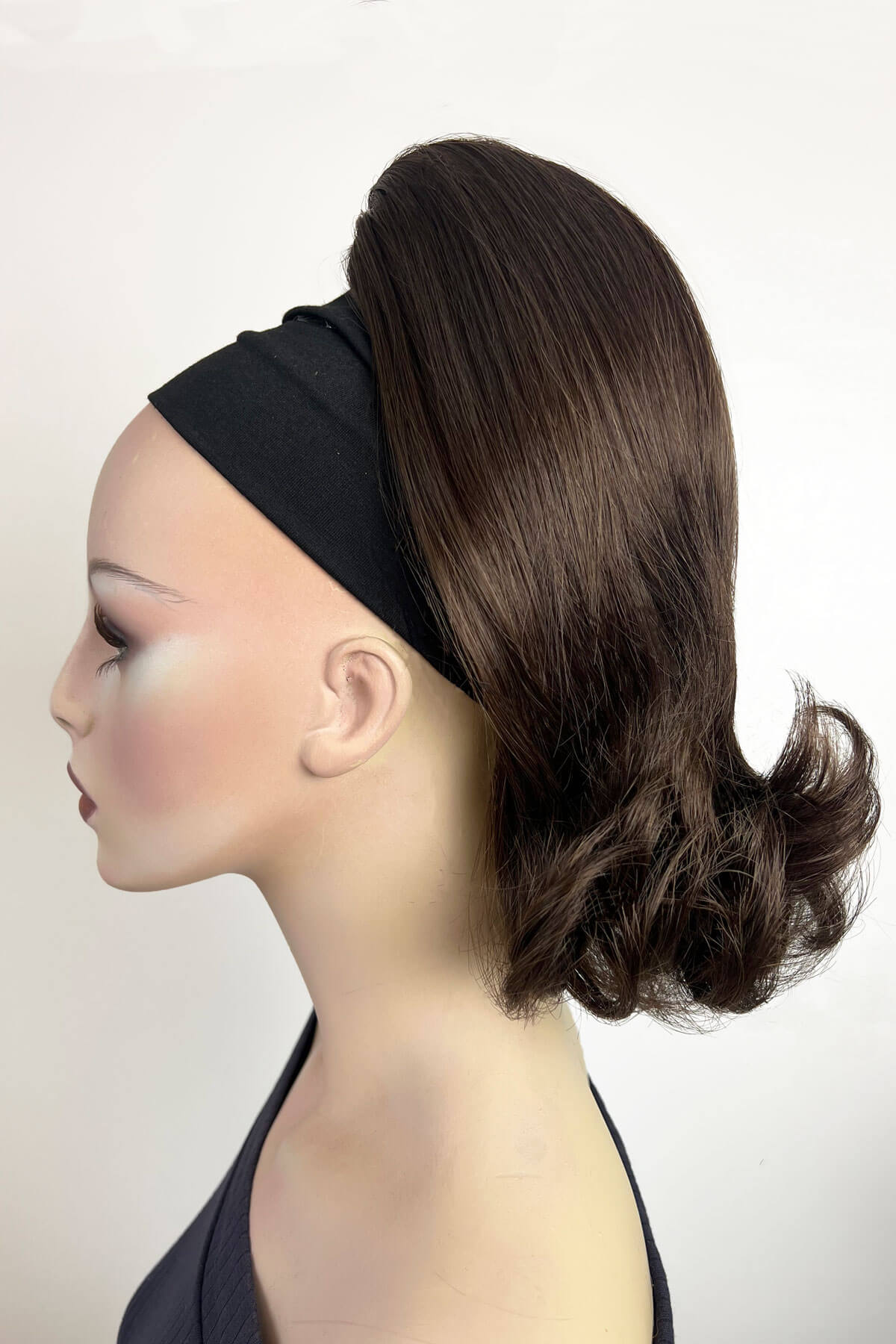 Mannequin head with a dark brown hairpiece and black headband on a white background. Ponytail hairpiece, shoulder length with flick/flip, retro 1960s style: Ariana chestnut brown 8