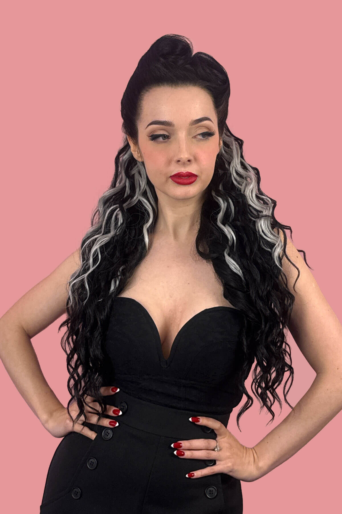 A woman in profile wearing a black strapless dress, showcasing a long, dark, curly wavy hair extension with grey streaks against a solid pink background. Long Curly Ponytail Hair Piece Extension, Black and Grey