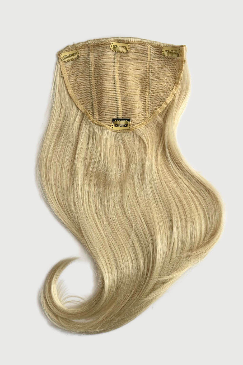 Blonde hair extension on a white background. Volume and Height Booster Hairpiece: Blaise - champagne blonde 613