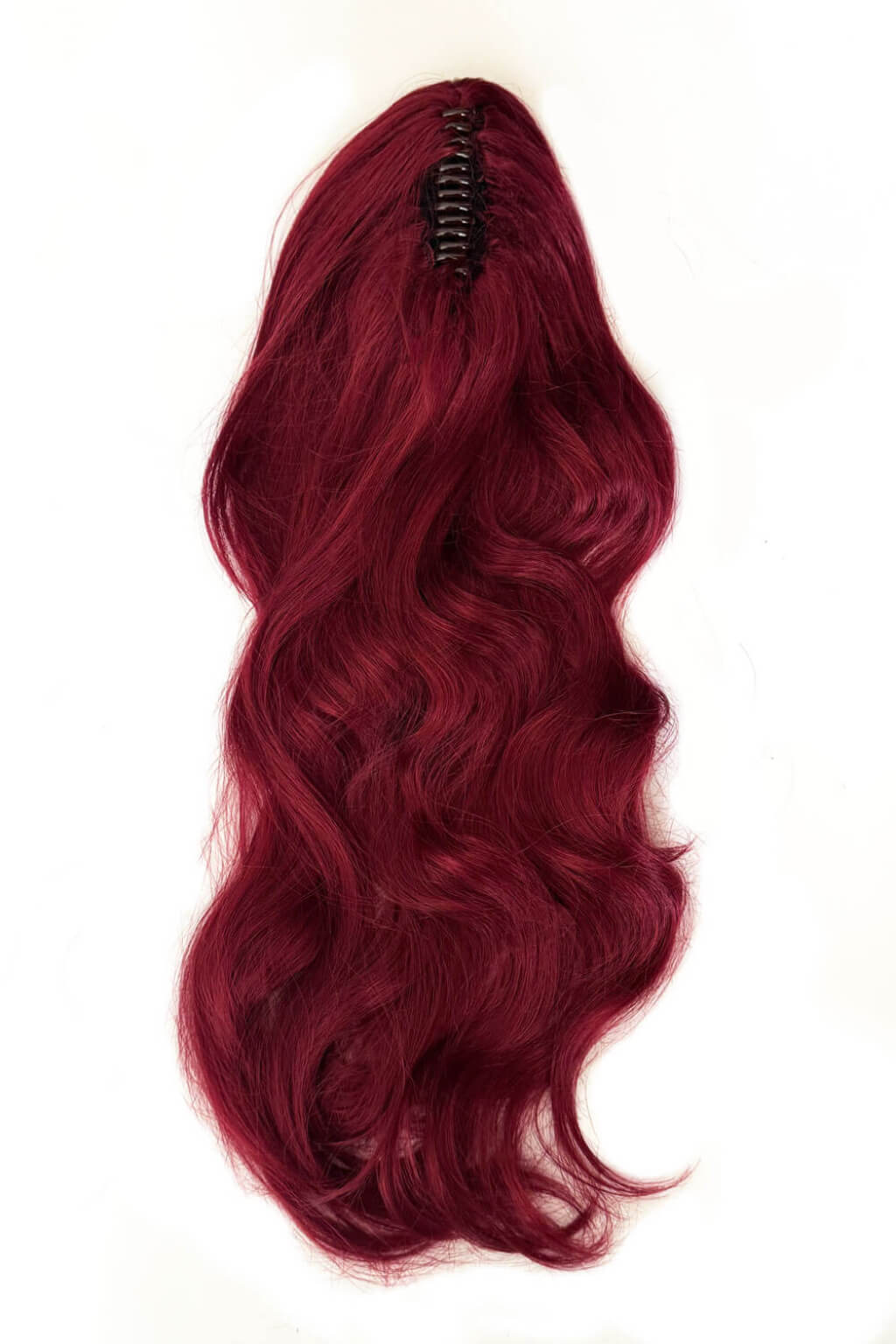 Red wig on a mannequin head against a white background. Clip-in ponytail hairpiece extension: Olivia Red 39