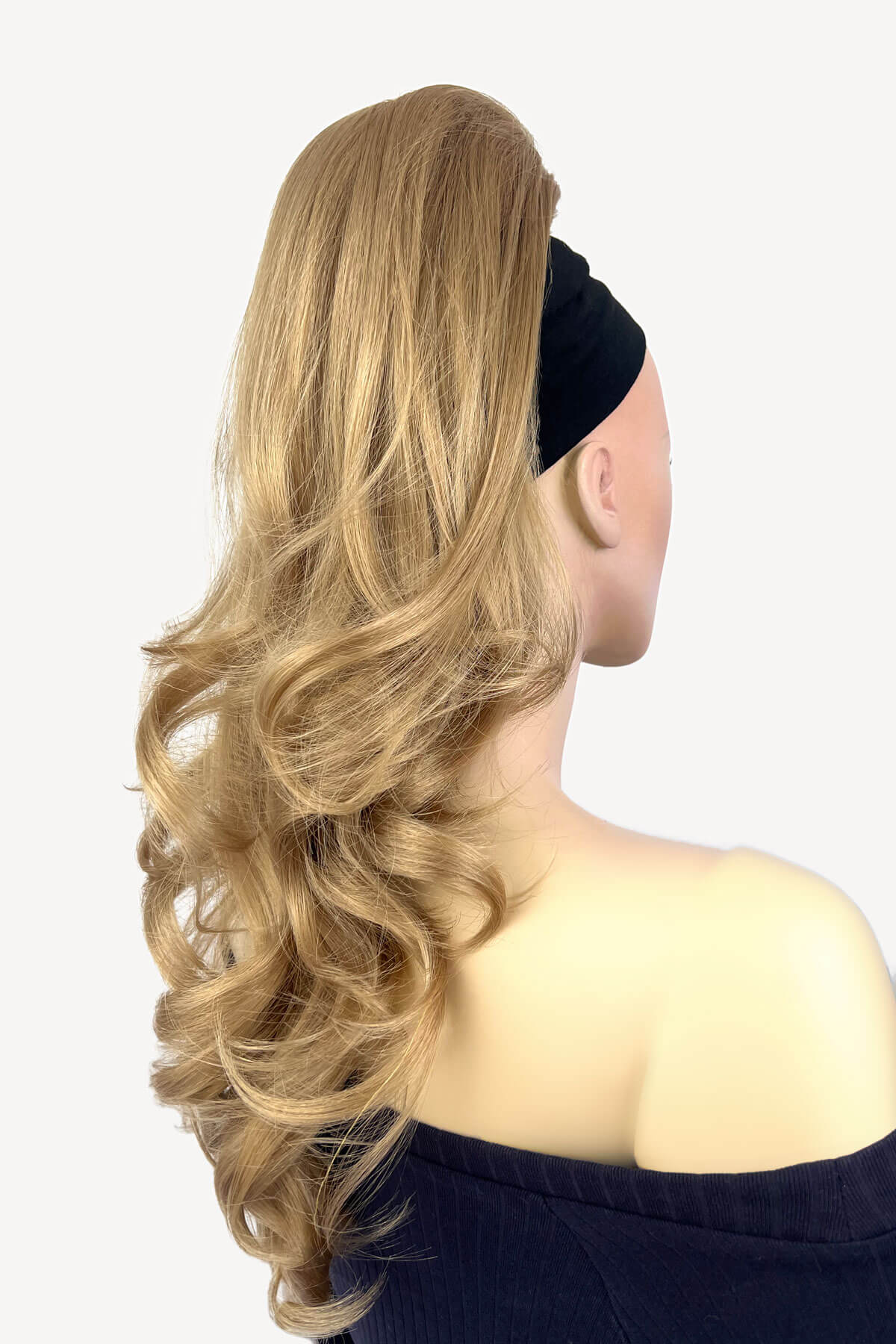 Blonde hair extension styled on a mannequin head against a plain background. Wavy, long ponytail hairpiece extension: Casey ash blonde 24