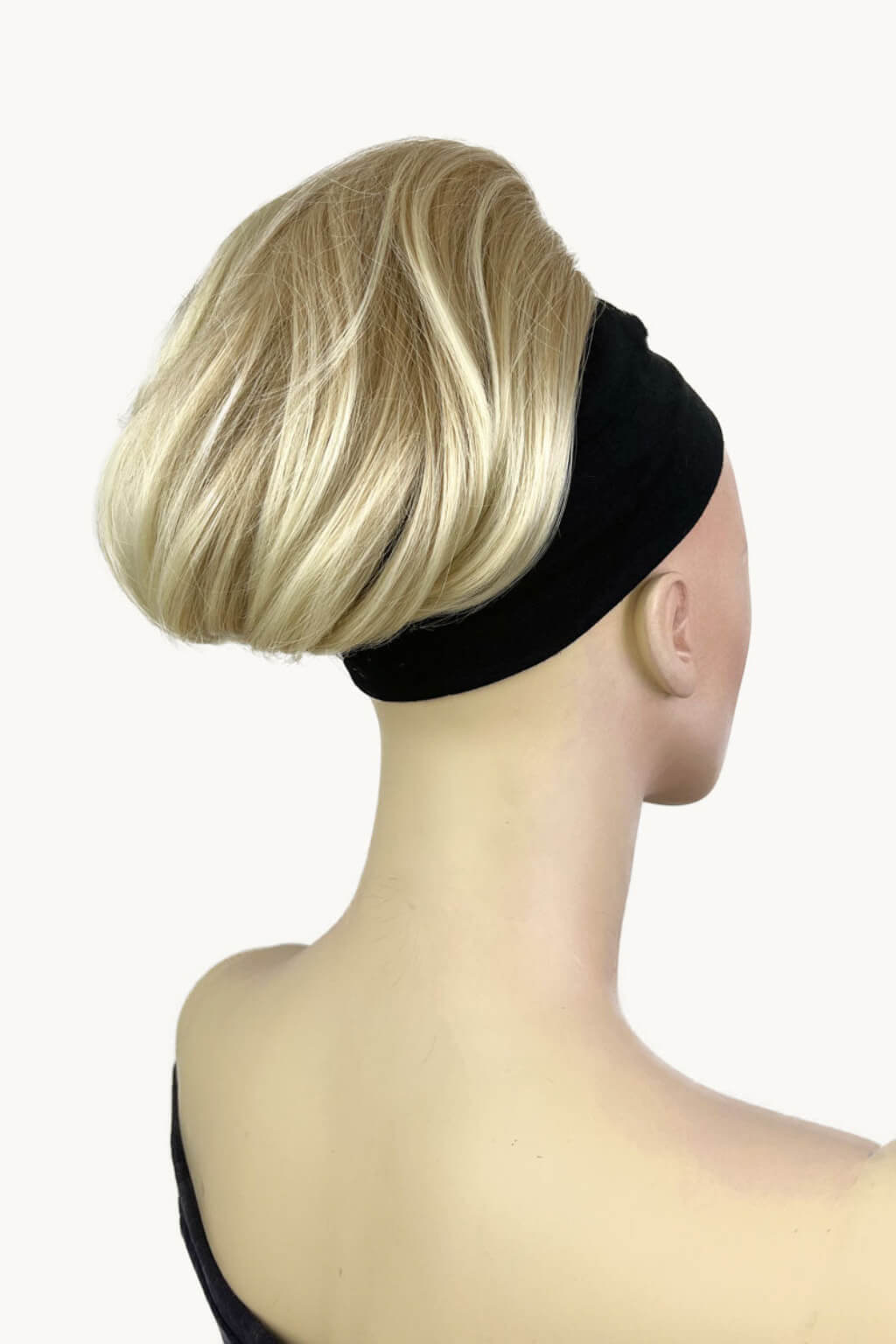 Mannequin head with blonde wig and black headband on a white background. Short ponytail extension hairpiece, straight, full & bouncy: Tanaya blonde 613T24