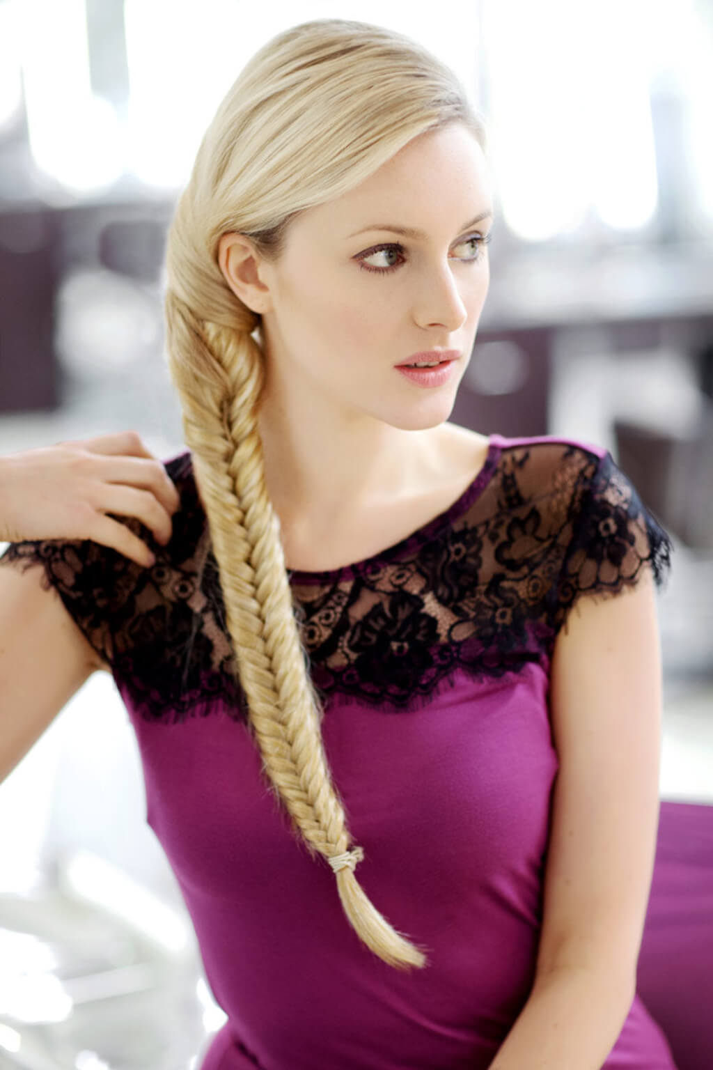 Woman with a braid wearing a purple dress with black lace details. Fishtail plait (braid) hairpiece extension: Tinsley