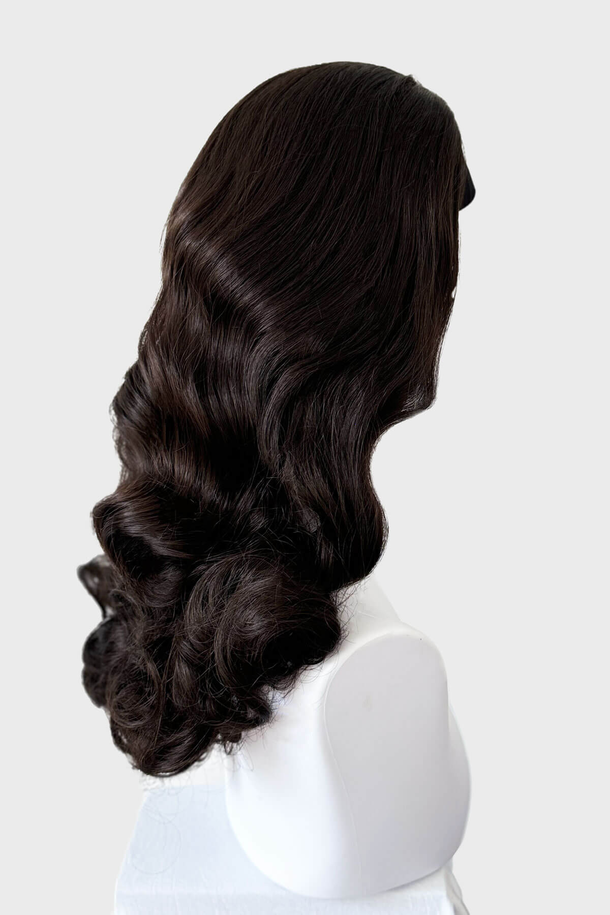 Dark brown wig on a mannequin head against a white background. 1950s style half wig hairpiece with beautiful waves: Morgana dark brown 6
