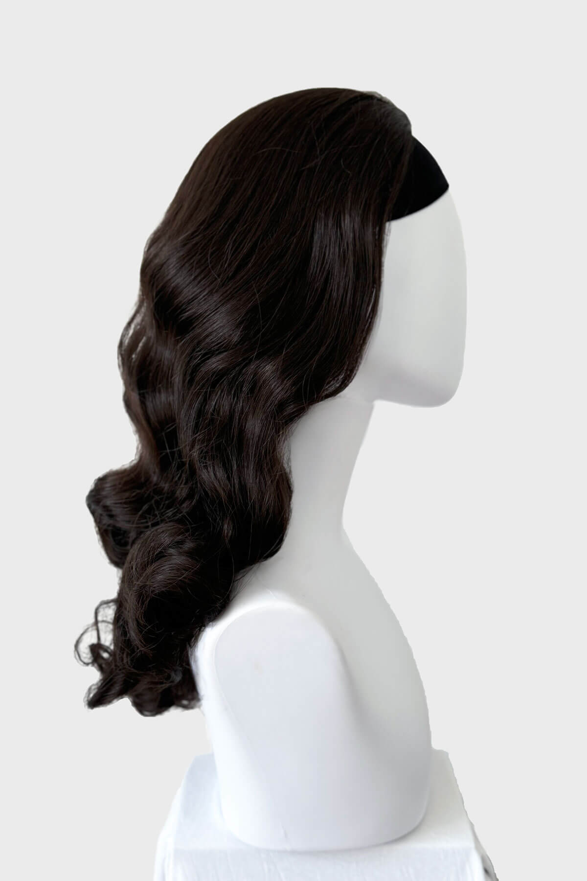 Dark brown wig on a mannequin head against a white background. 1950s style half wig hairpiece with beautiful waves: Morgana dark brown 6