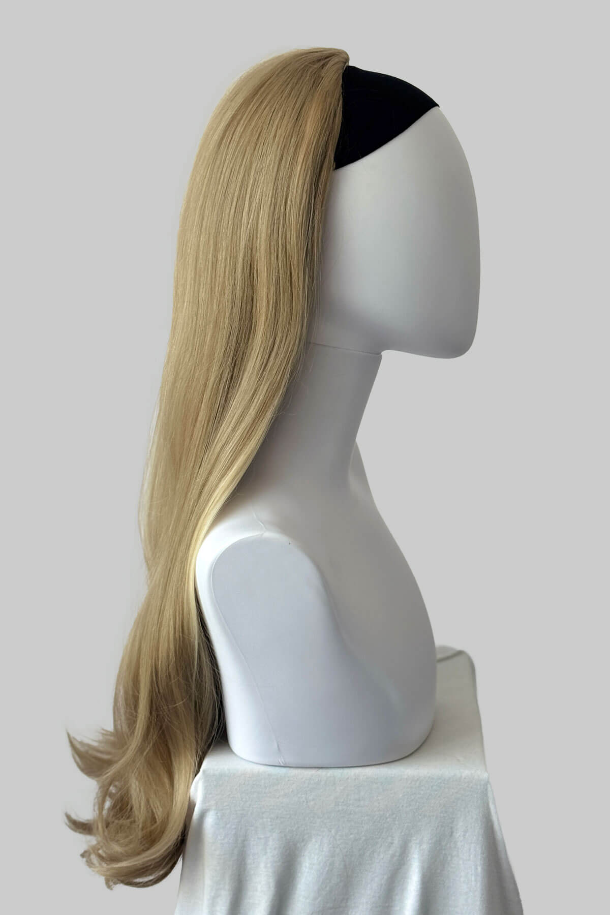 Mannequin head with ash blonde half wig on a plain background. Kate - Heat Styleable Extra Long, Gentle Wave Half Wig  blonde 24H613