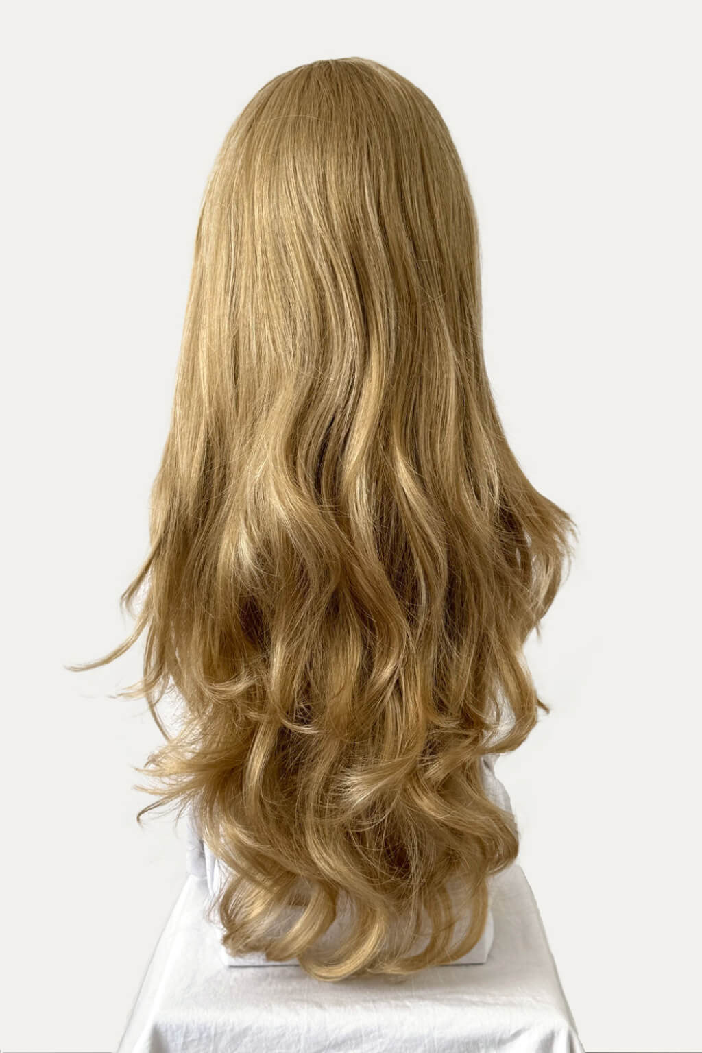 A long, wavy blonde wig with a black headband, displayed on a white mannequin head against a plain white background. Blonde half wig hairpiece (3/4 wig), loose curls: Suki blonde 24H613