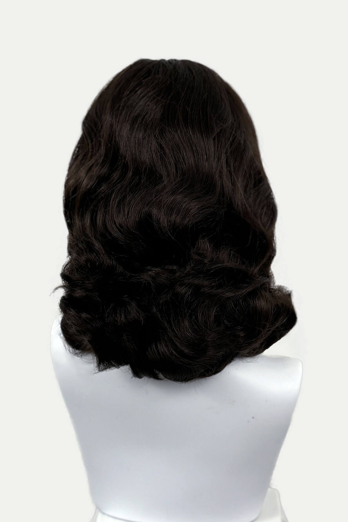 Dark chocolate brownwig on a mannequin head against a white background viewed  from the back. 1950s style shoulder length half wig hairpiece with beautiful vintage waves: Onyx dark chocolate brown 6