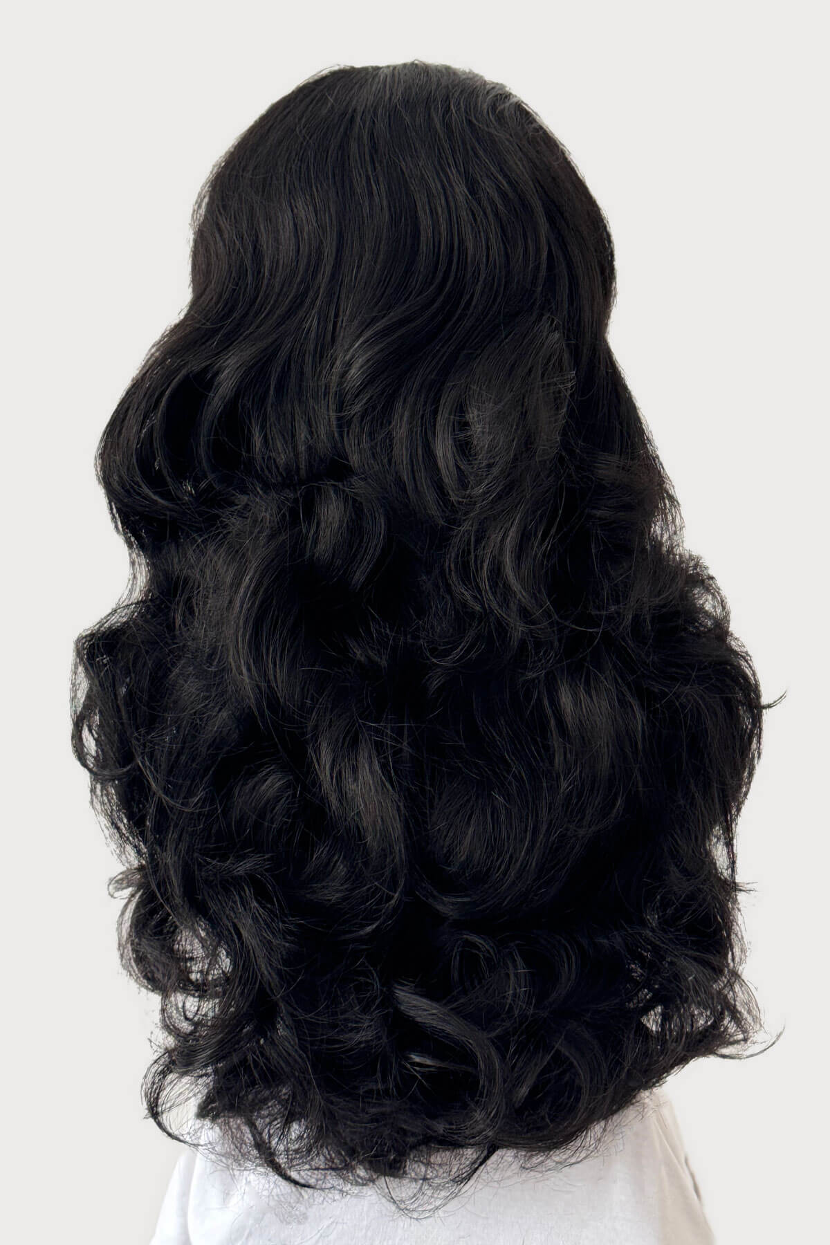 Black wavy hair extension on a white background. Curly black half wig hairpiece, long: Vicky
