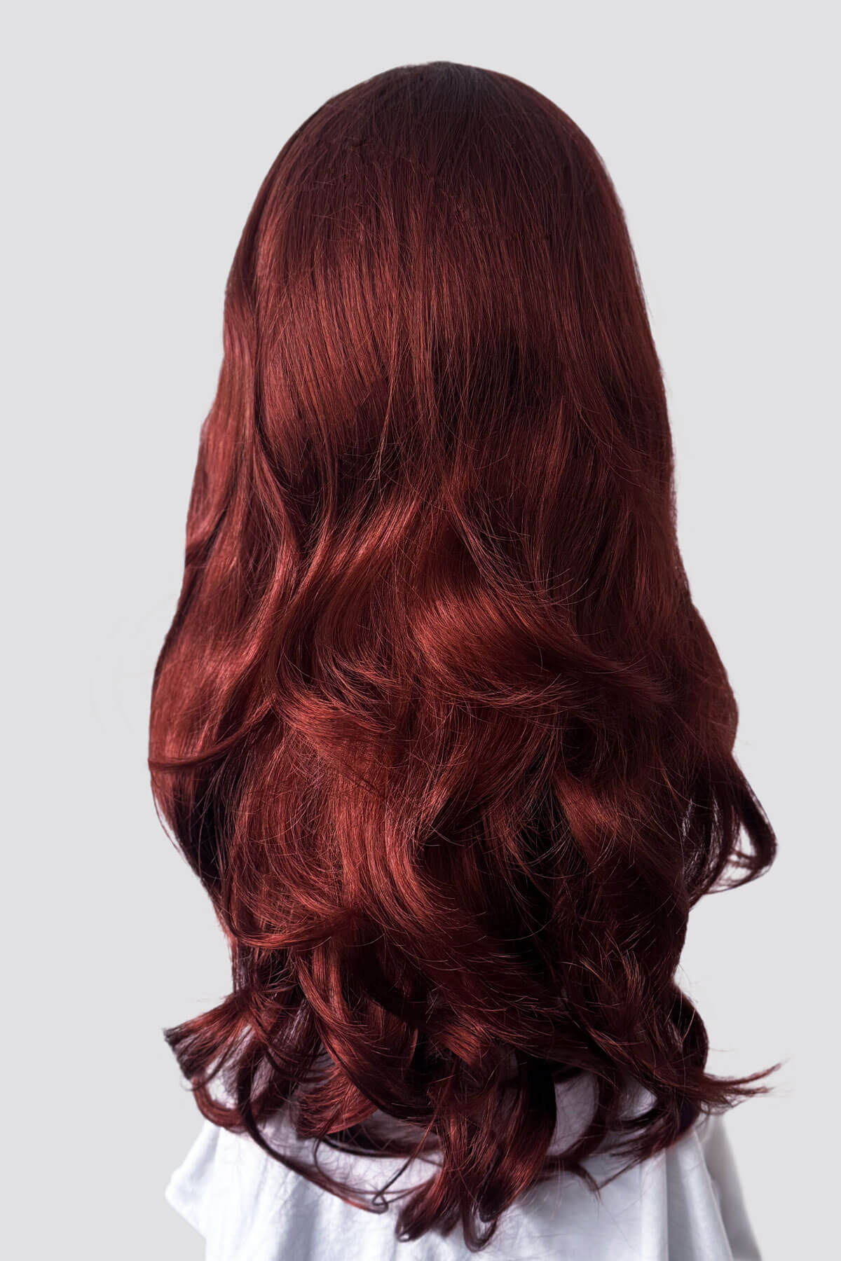 Long, wavy red hair on a white background. Red half wig (3/4 hairpiece) with long waves: Sasha copper red 130