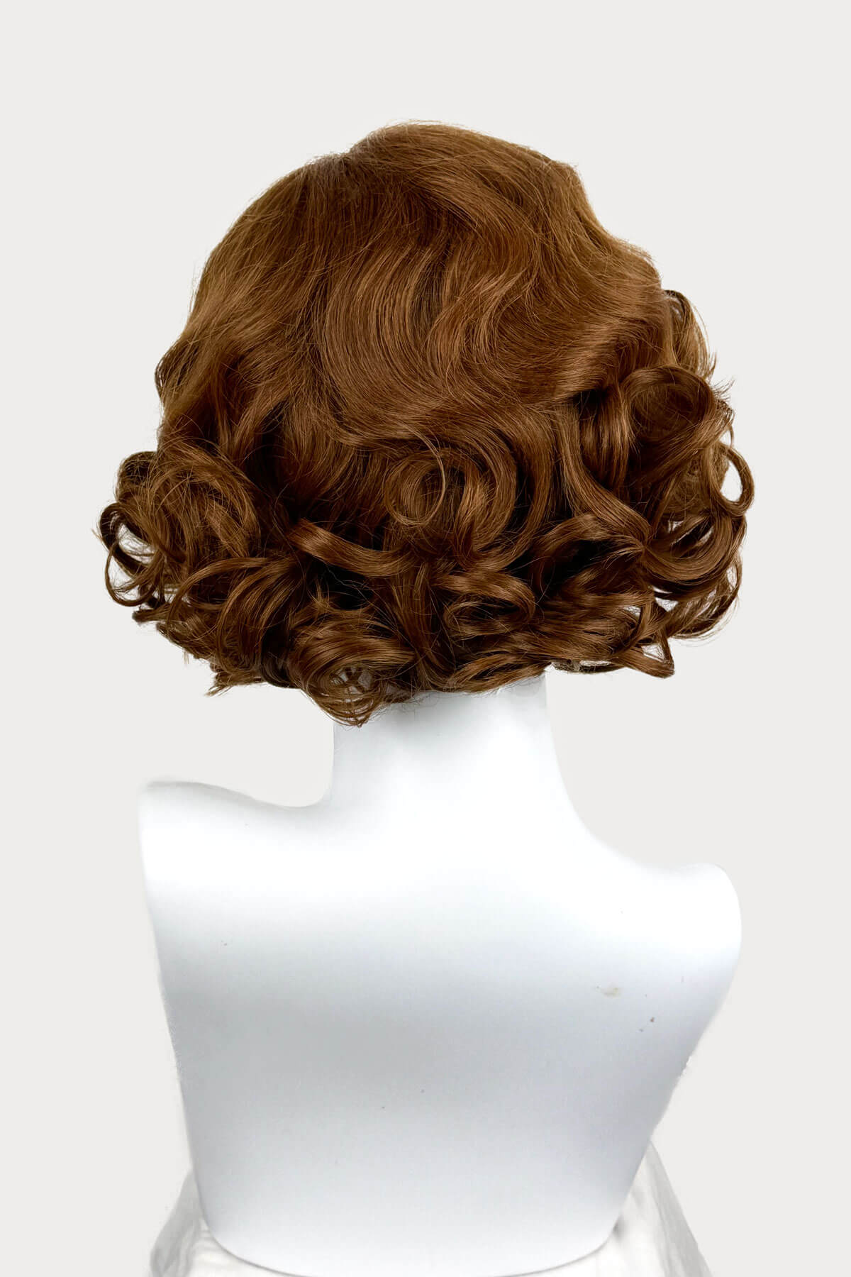 Auburn brown wavy wig on a mannequin head against a white background. Auburn pinup wig, lace front, vintage style: Tawney