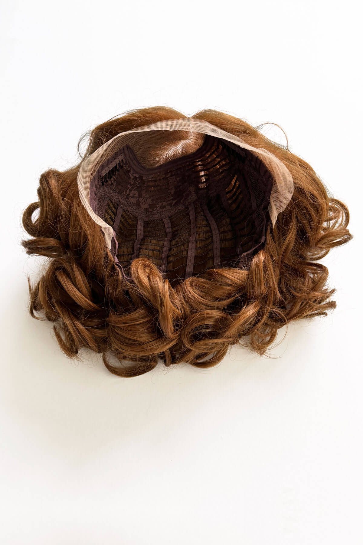 Auburn brown hairpiece with curly texture on a white background. Auburn pinup wig, lace front, vintage style: Tawney