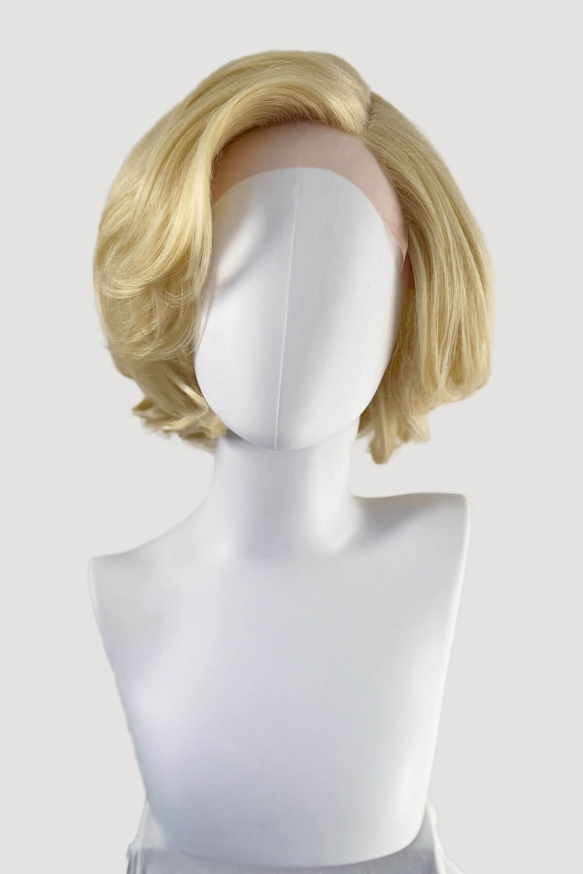 Blonde wig on a mannequin head against a white background. Blonde lacefront wig, pinup/vintage style, mid length, hollywood elegance: Norma Jeane