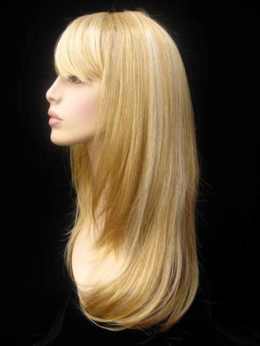A shoulder-length straight blonde wig with side-swept bangs, displayed on a mannequin head against a black background. Long blonde wig, face framing with long, side-sweeping fringe: Ashley golden blonde 24BH613