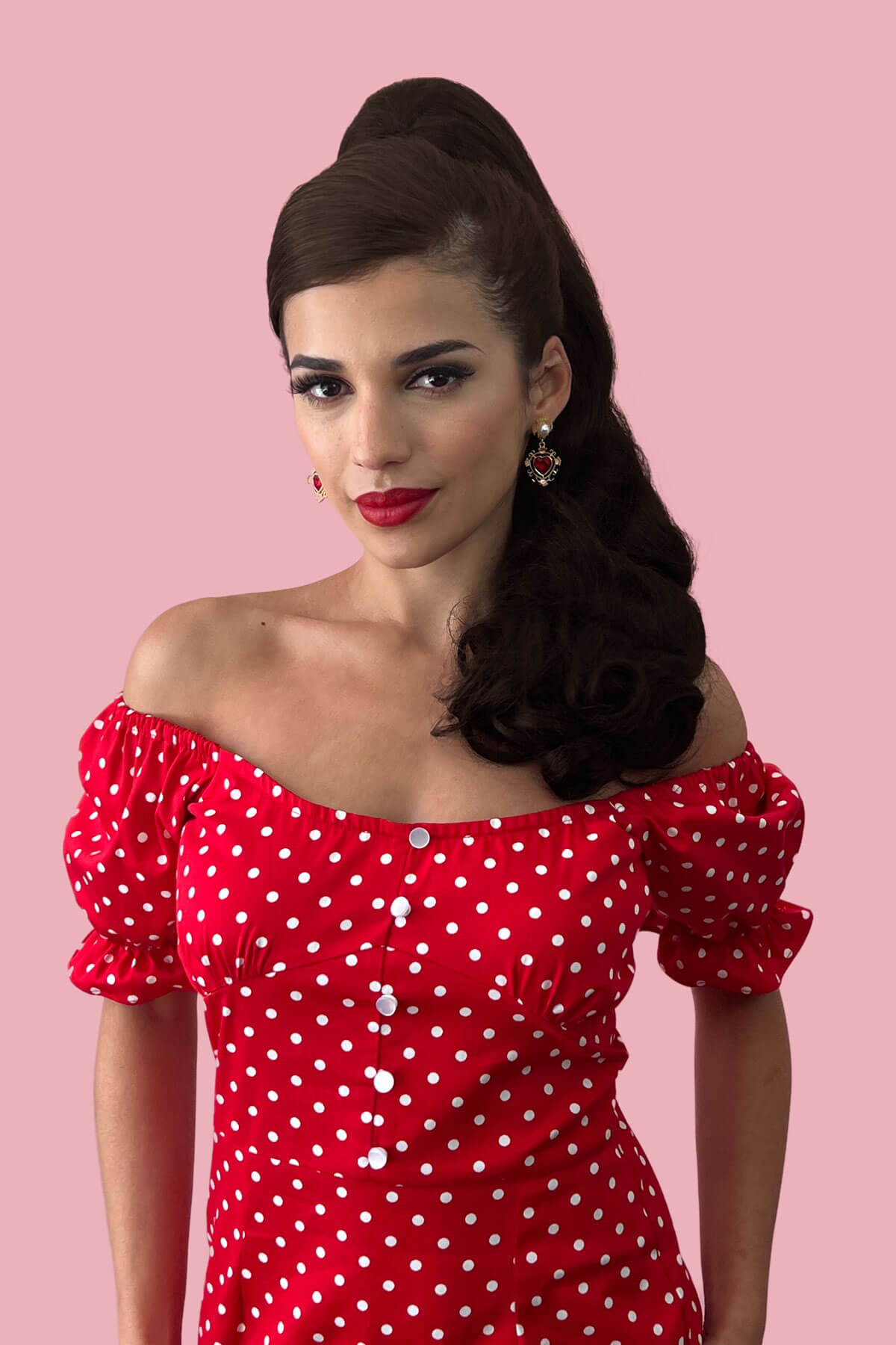 Woman wearing a red polka dot dress against a pink background. Retro style ponytail hairpiece, long with vintage waves: Arabella  chestnut brown 8