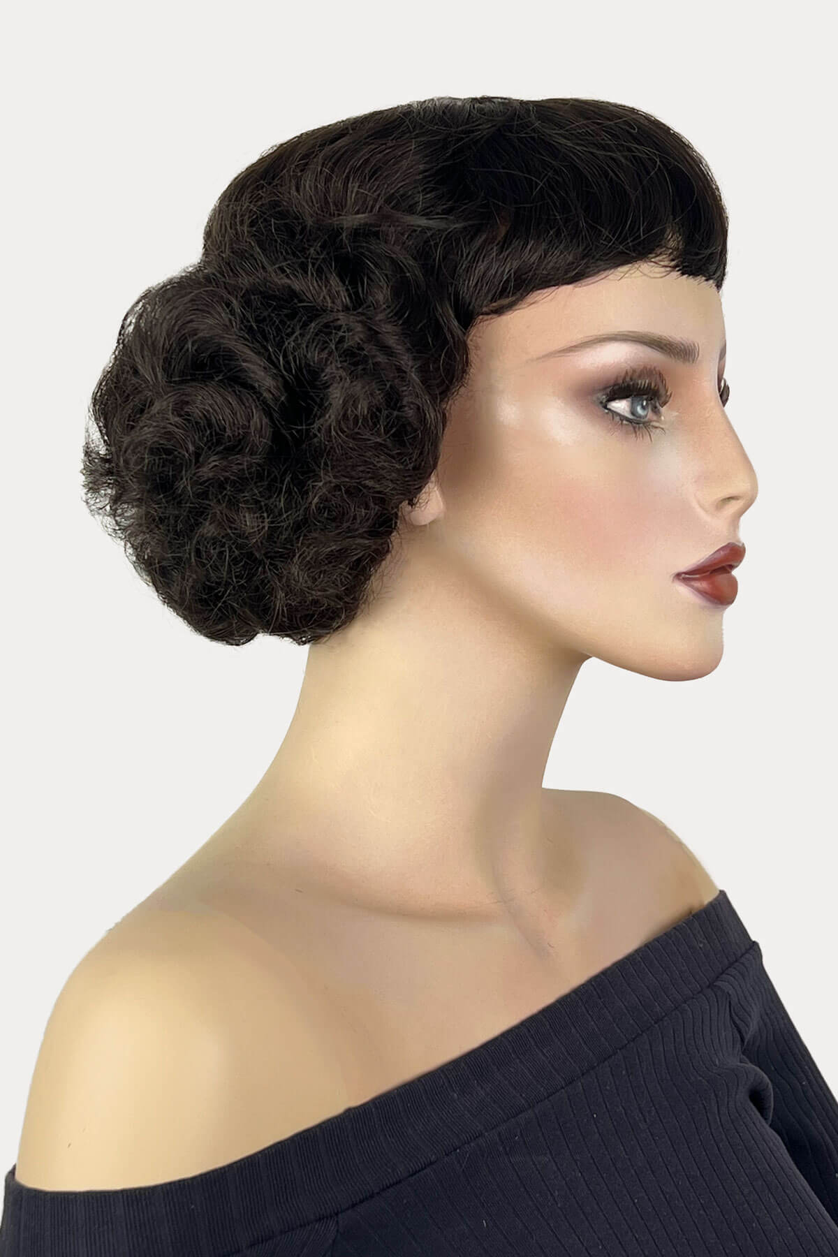 Woman with styled hair and makeup on a white background. A short brown vintage style wig with waves: Rita dark brown 4