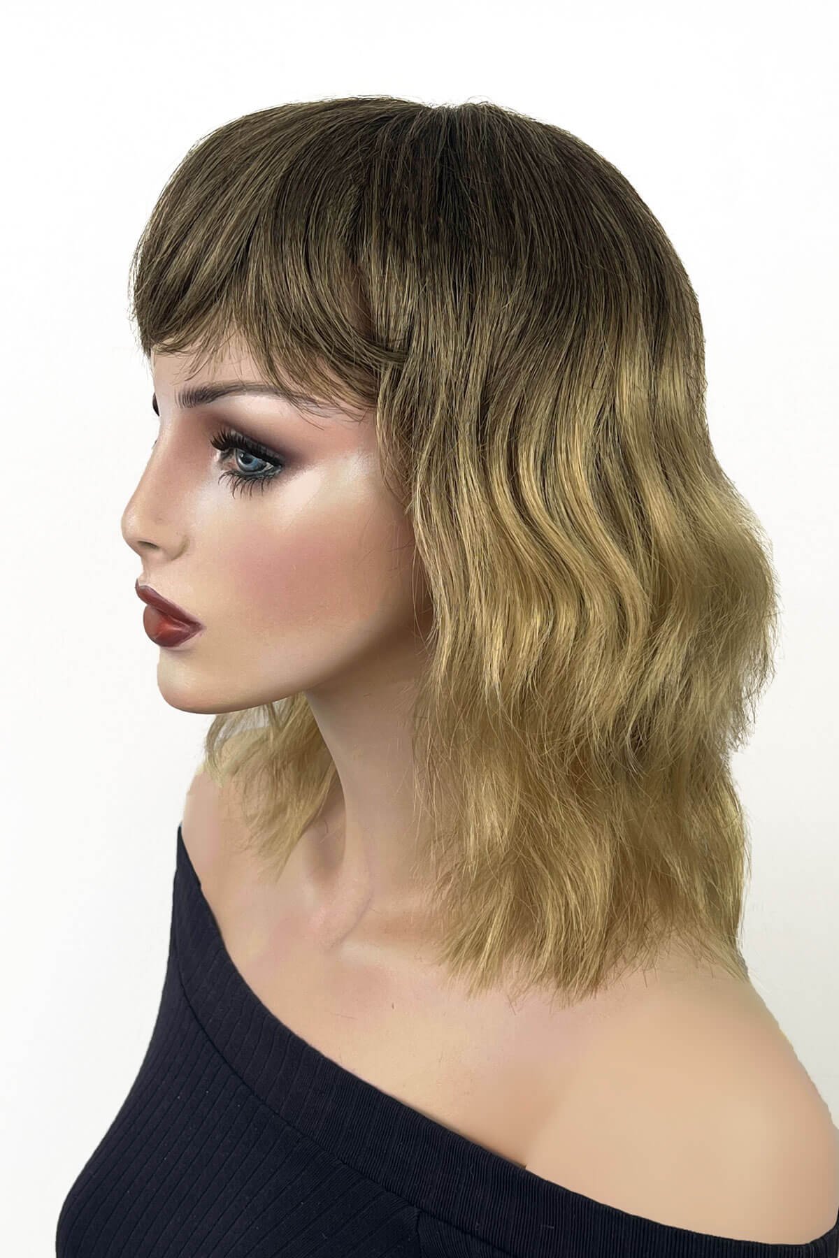 A shoulder-length wavy wig with side-swept bangs, shown on a mannequin head against a plain white background. Long dark brown bob wig (LOB) with textured waves: Anais 8TN24