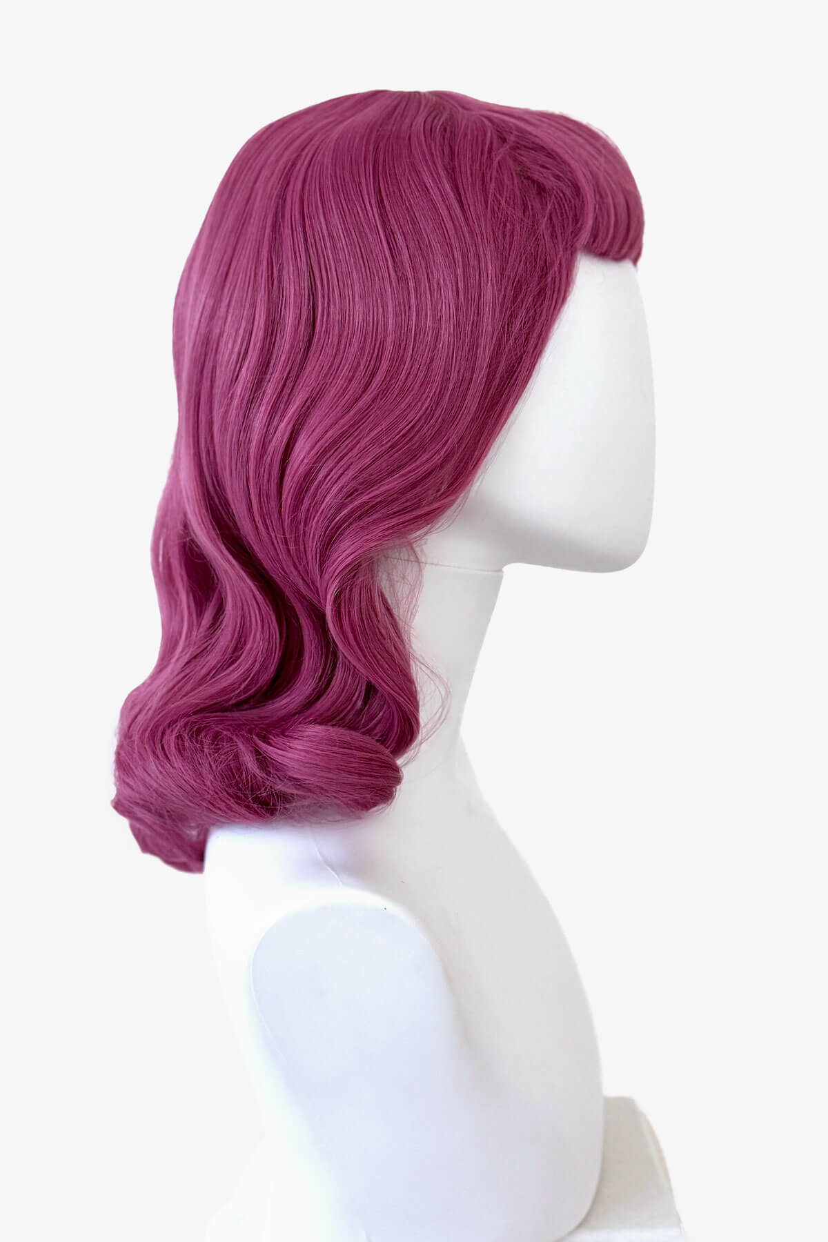 Purple wig on a white mannequin head against a white background. Pink pinup style wig, with finger waves and a short fringe, 1950s style: Stevie 2520J