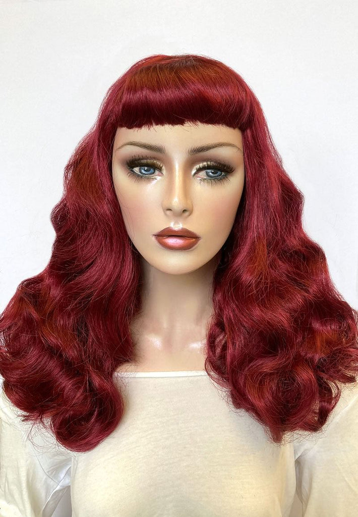 Long cherry red pin-up style wig, gently wavy with short fringe: Maeve AnnabellesWigs